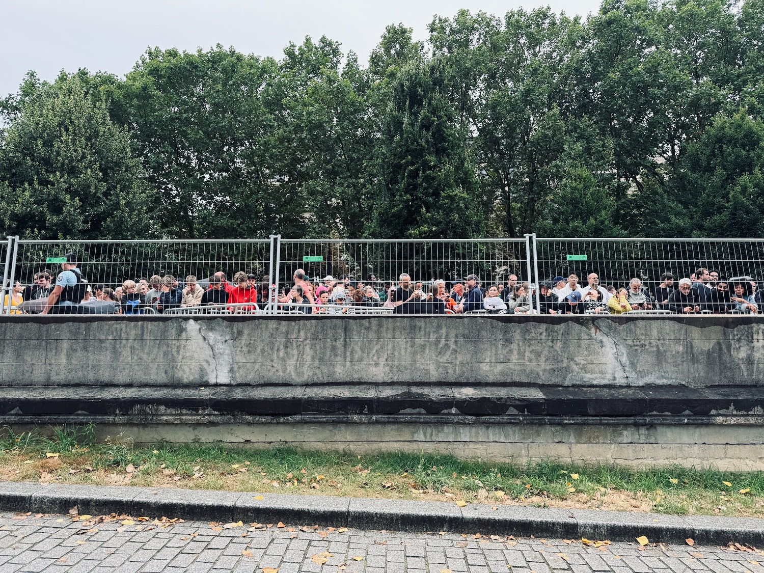 a group of people sitting on a wall