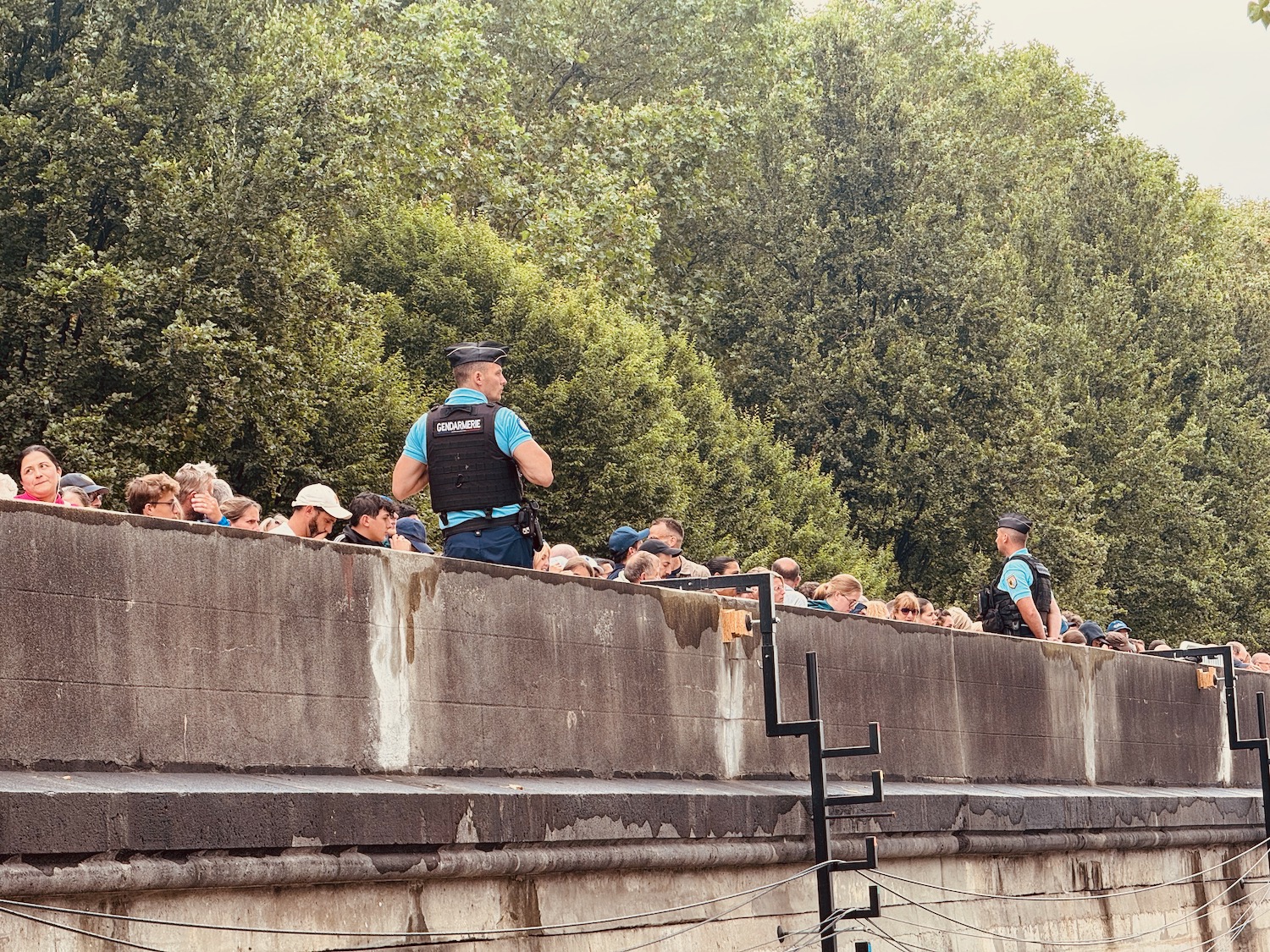 a man standing on a wall with a crowd of people