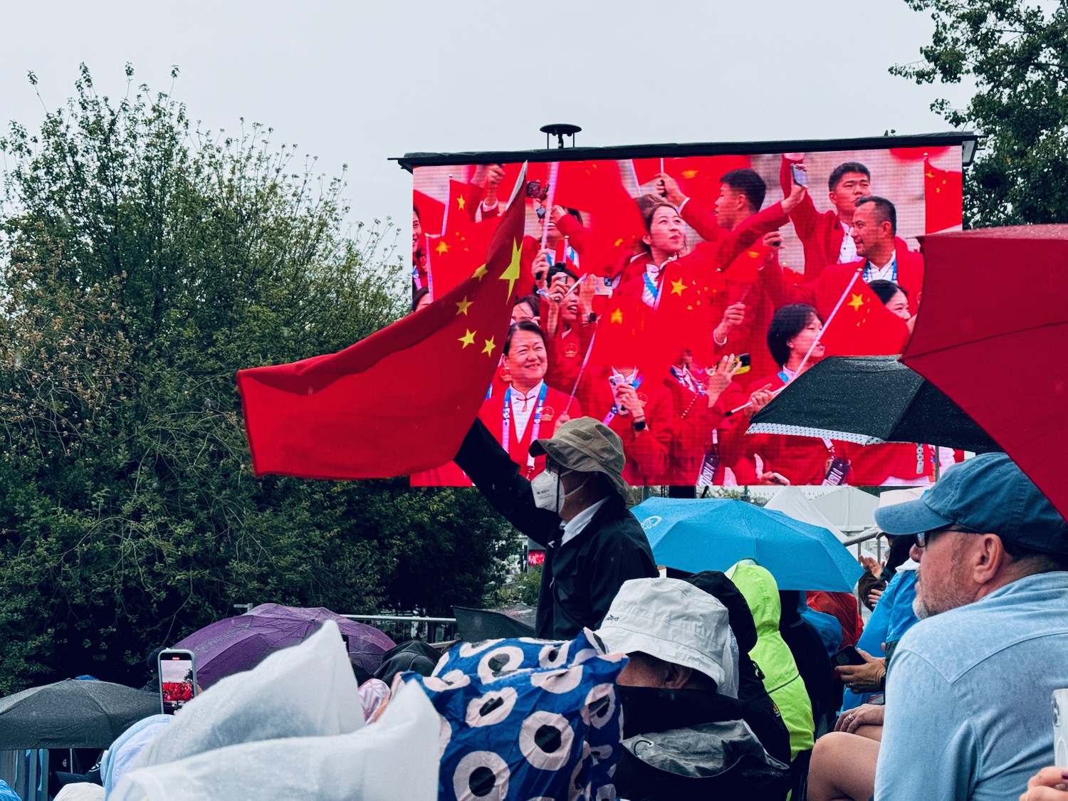 a group of people standing in front of a large screen