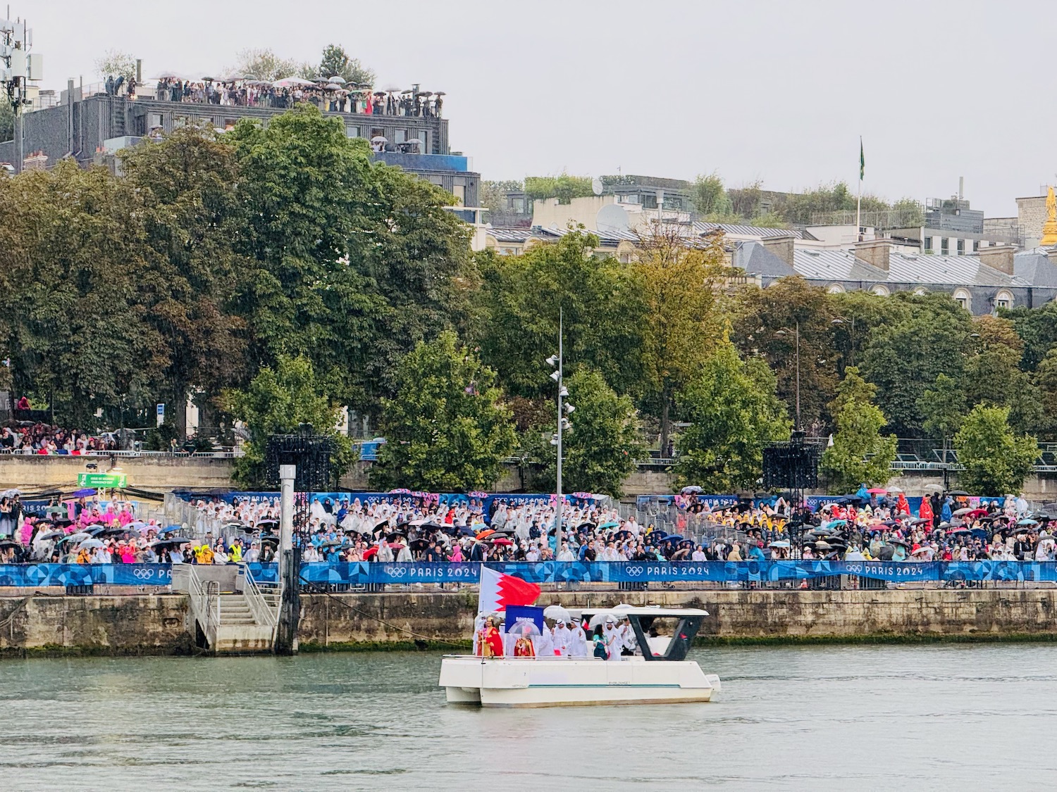 a boat on the water with a crowd of people in the background