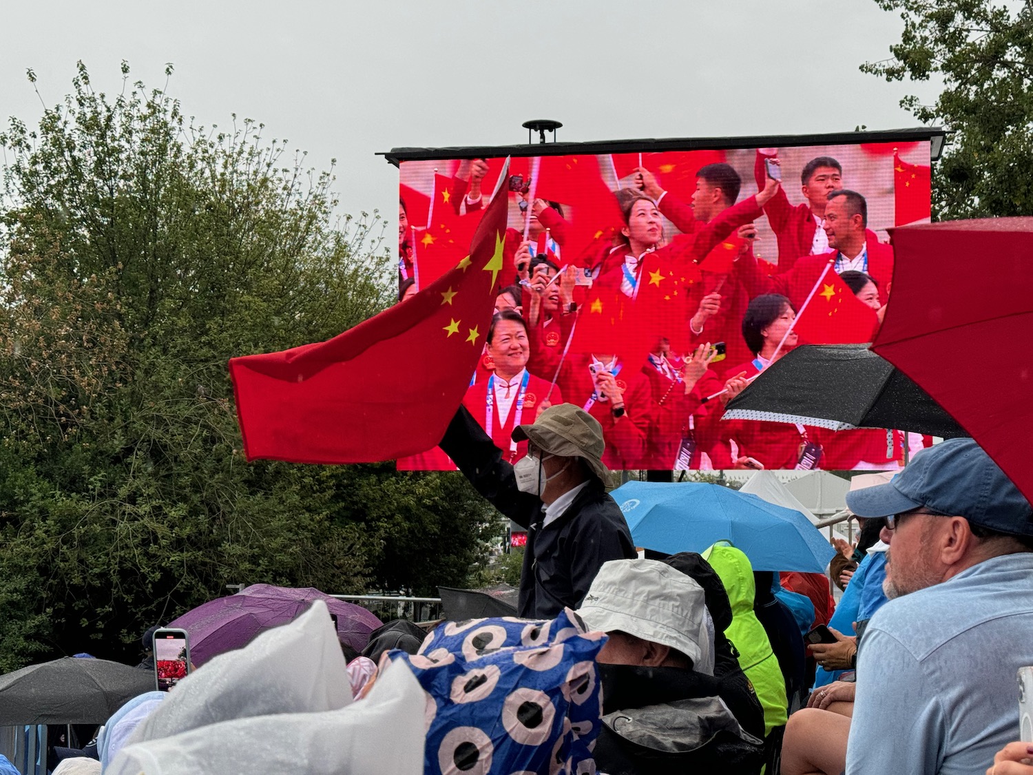 a group of people standing in front of a large screen