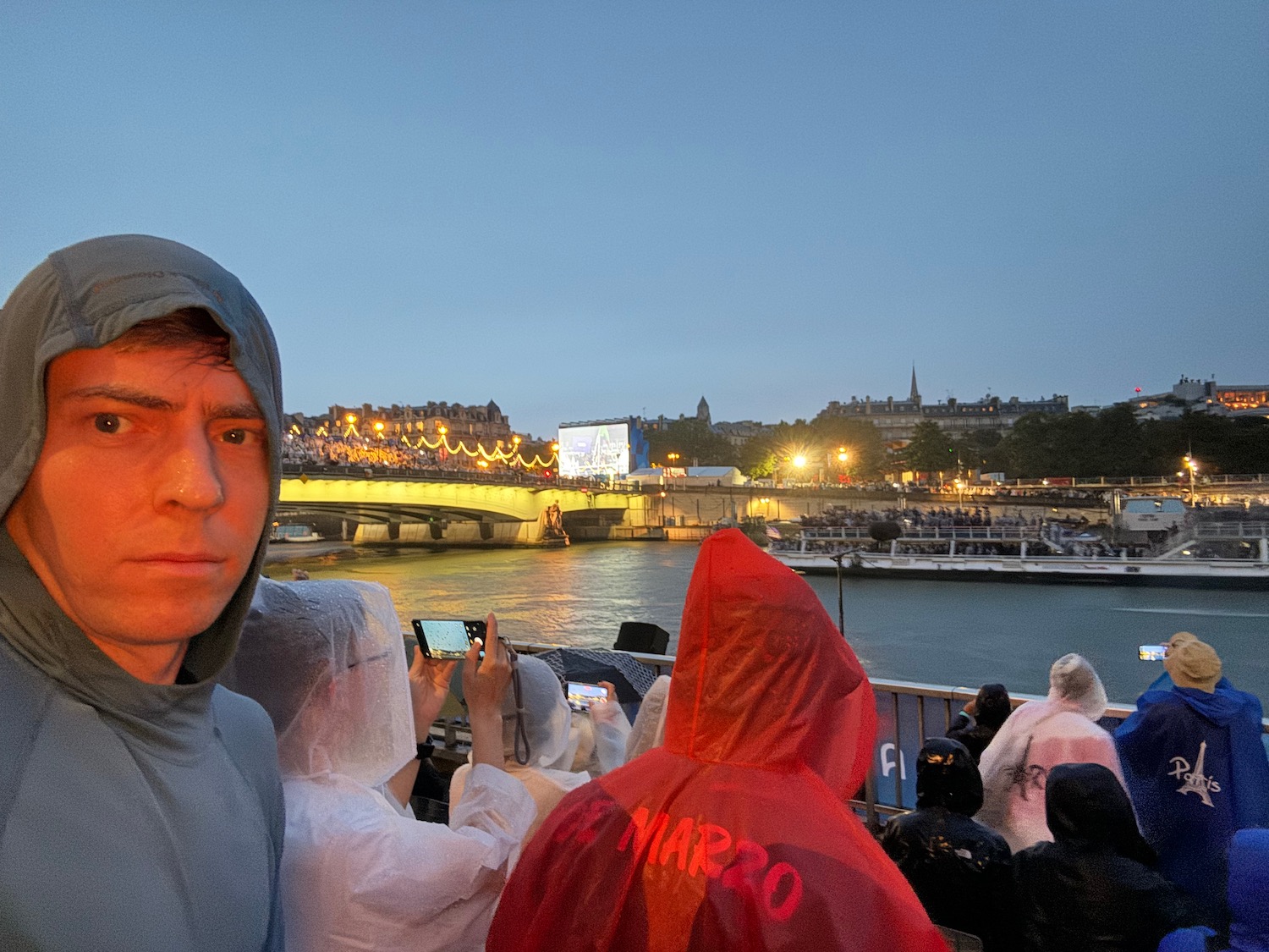 a man taking a selfie with a river and a bridge