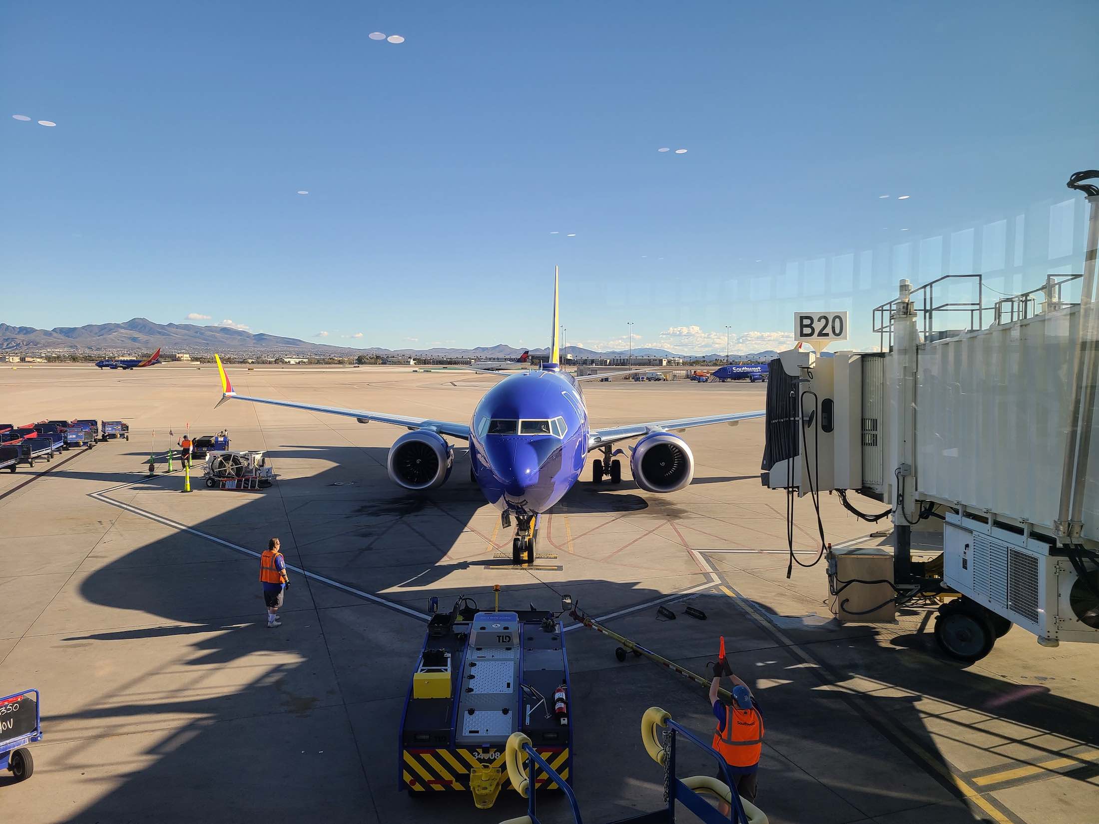 a blue airplane on the tarmac