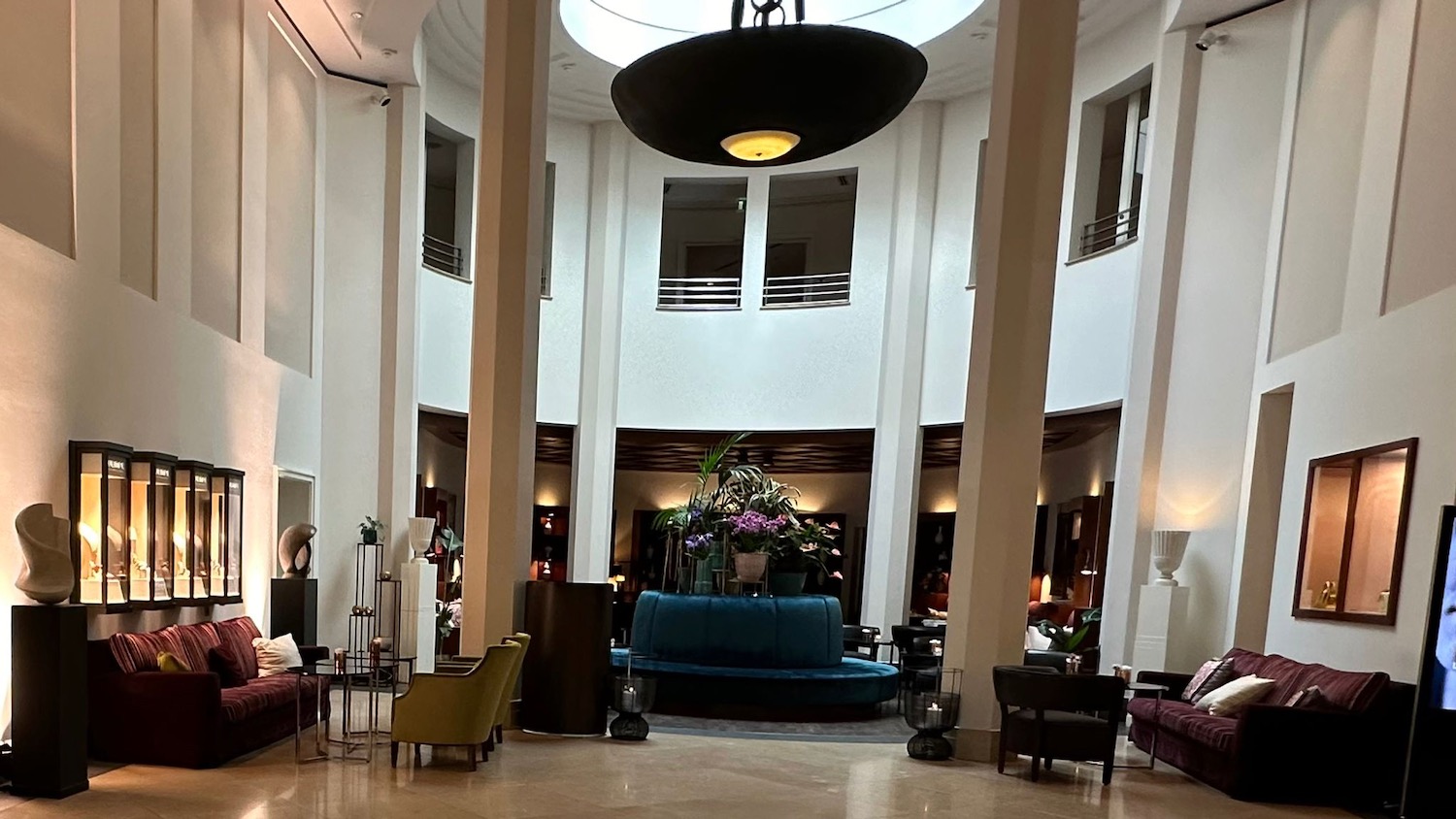 a room with a round ceiling and a blue couch