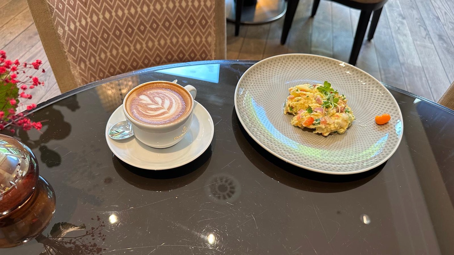 a cup of coffee and a plate of food on a table