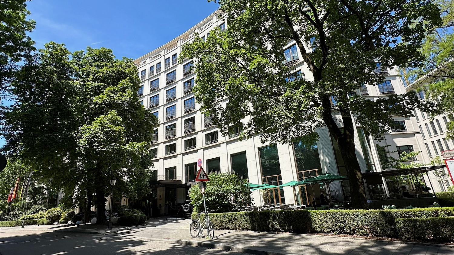 a building with trees and a bicycle