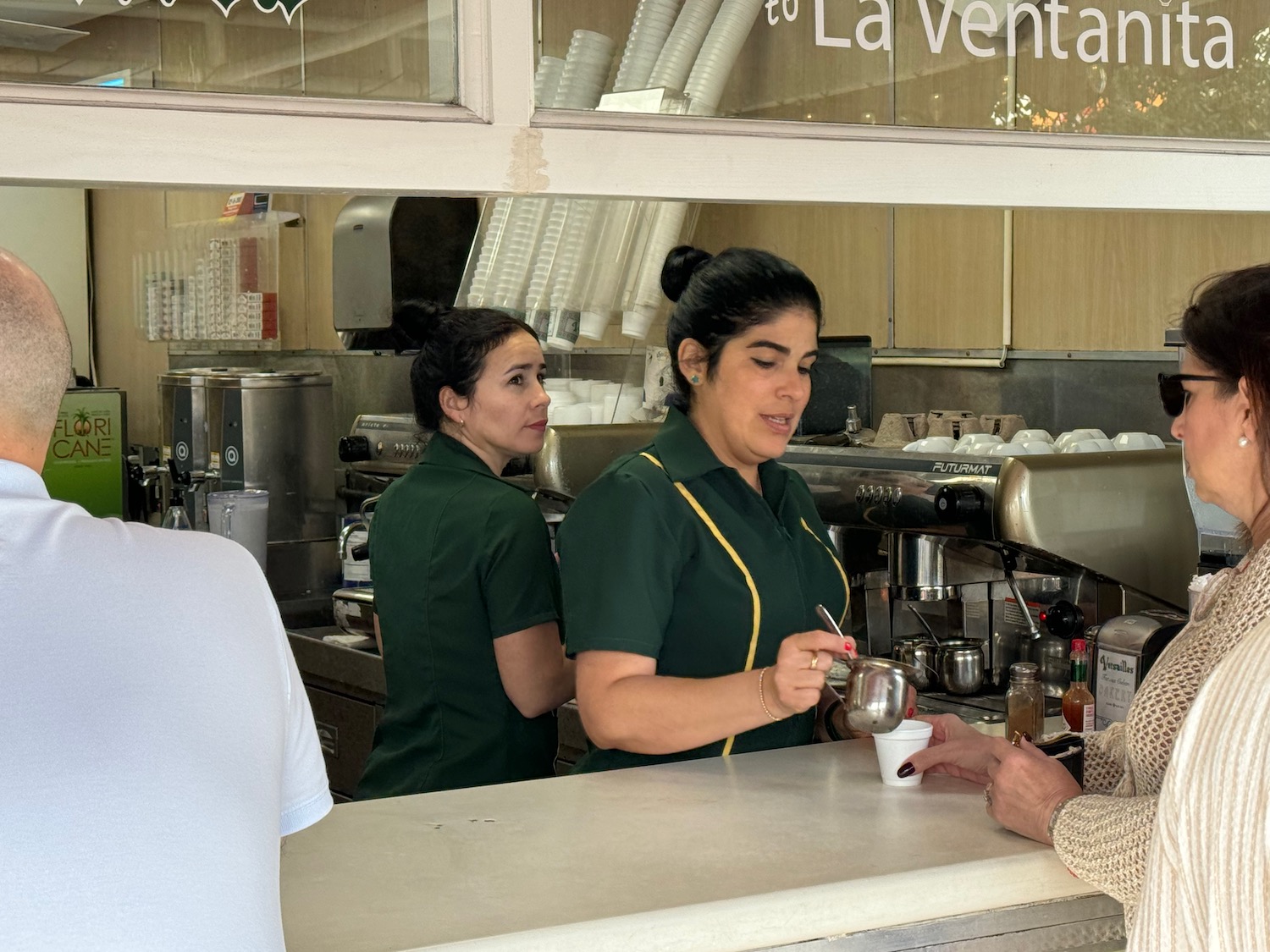 a woman serving a cup of coffee