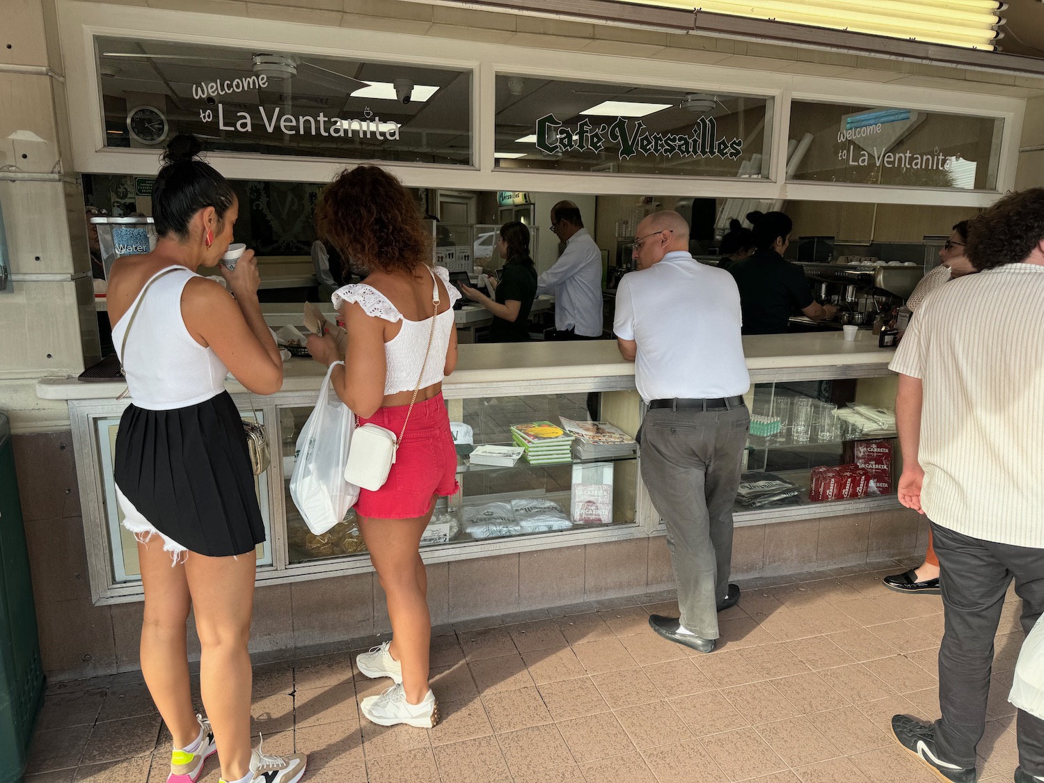 a group of people standing in front of a store