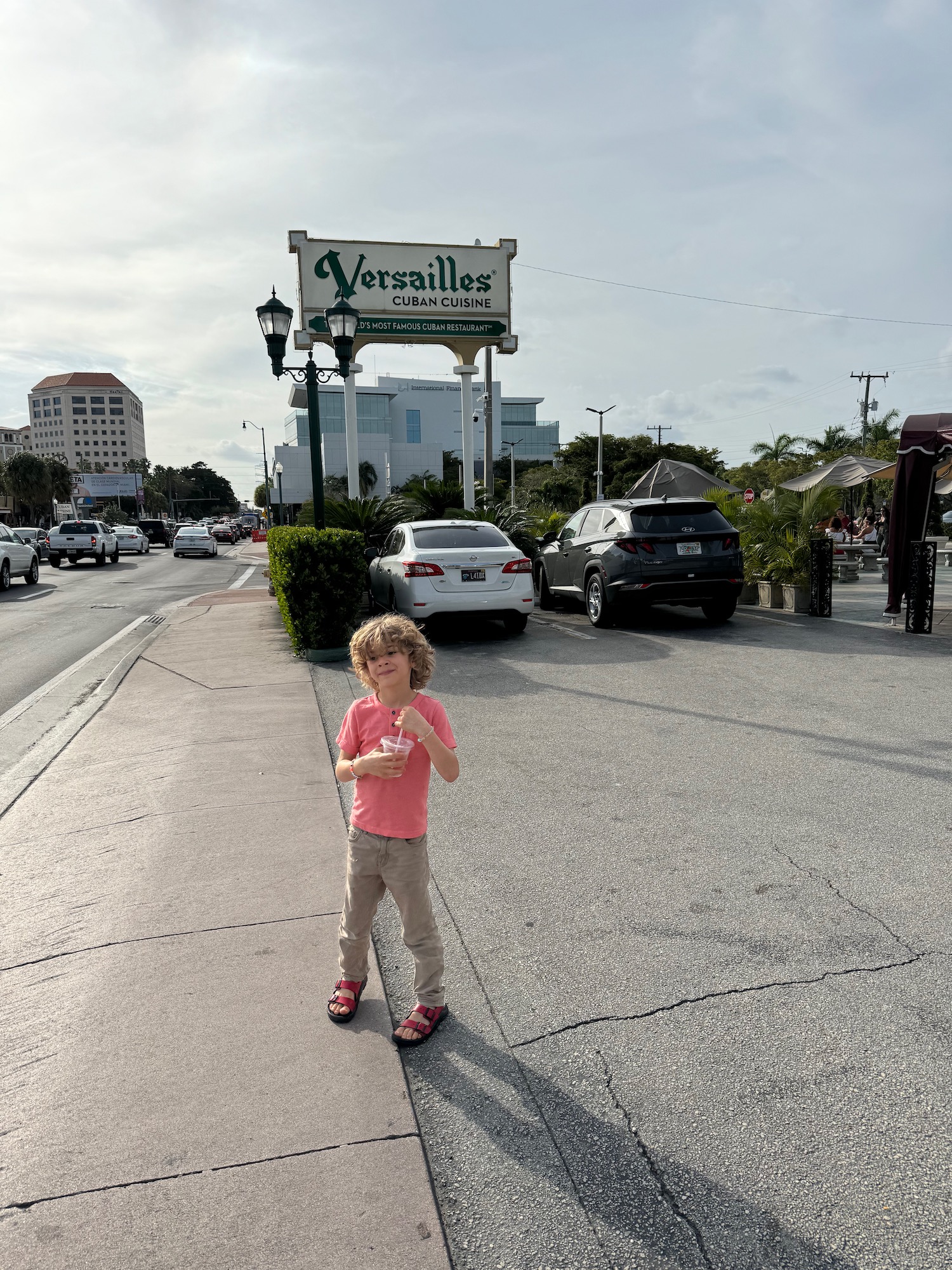 a child standing on a sidewalk