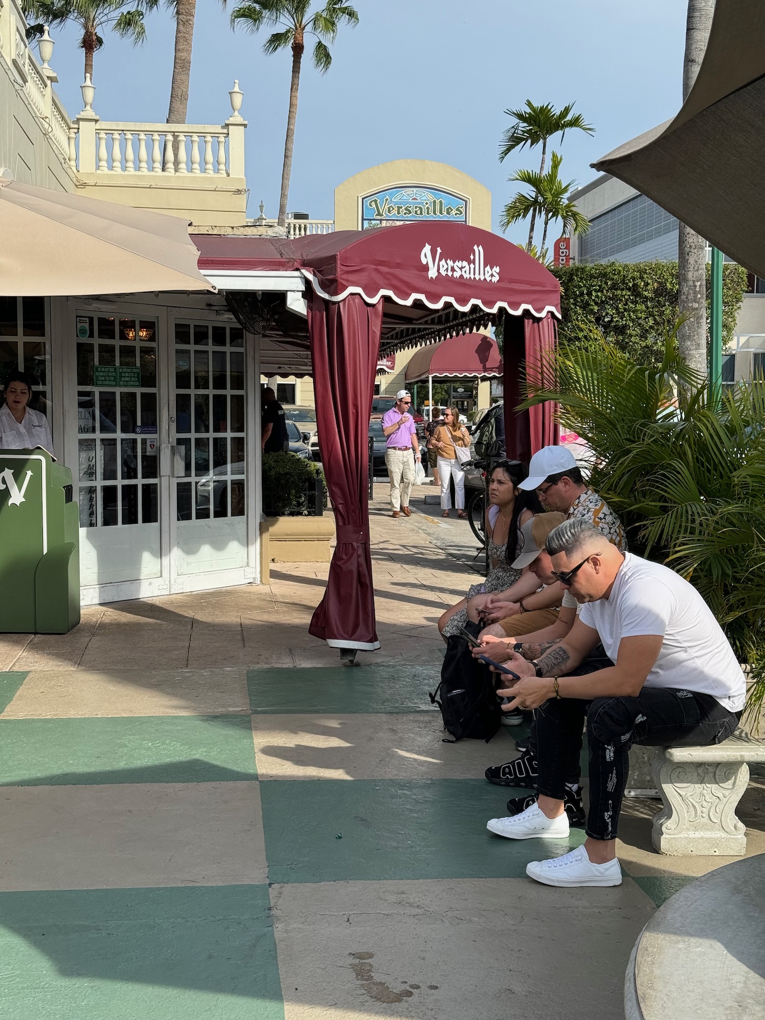 a group of people sitting on a bench outside a store