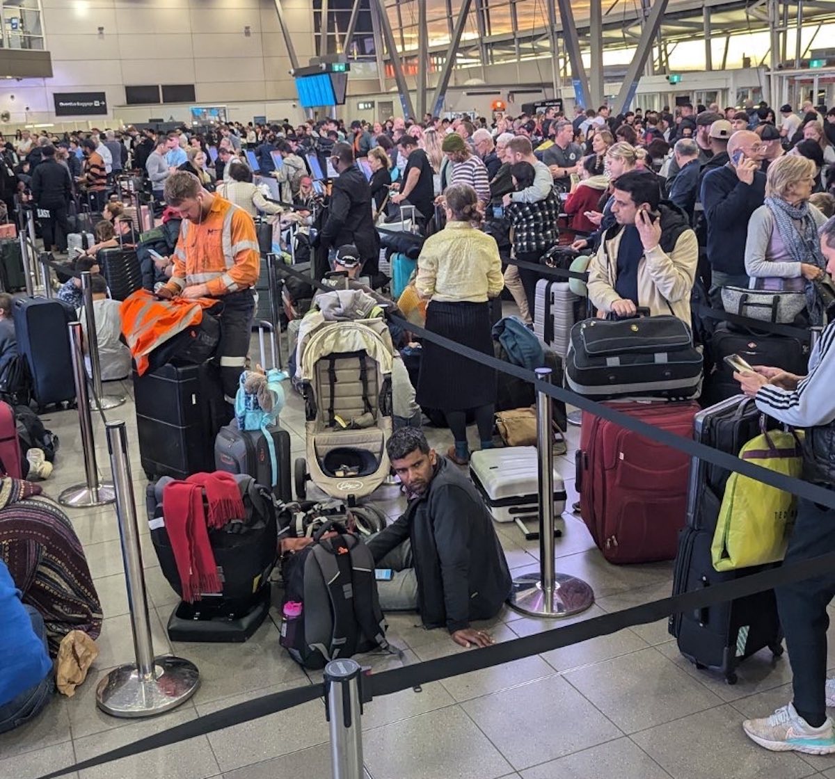 a large crowd of people in an airport