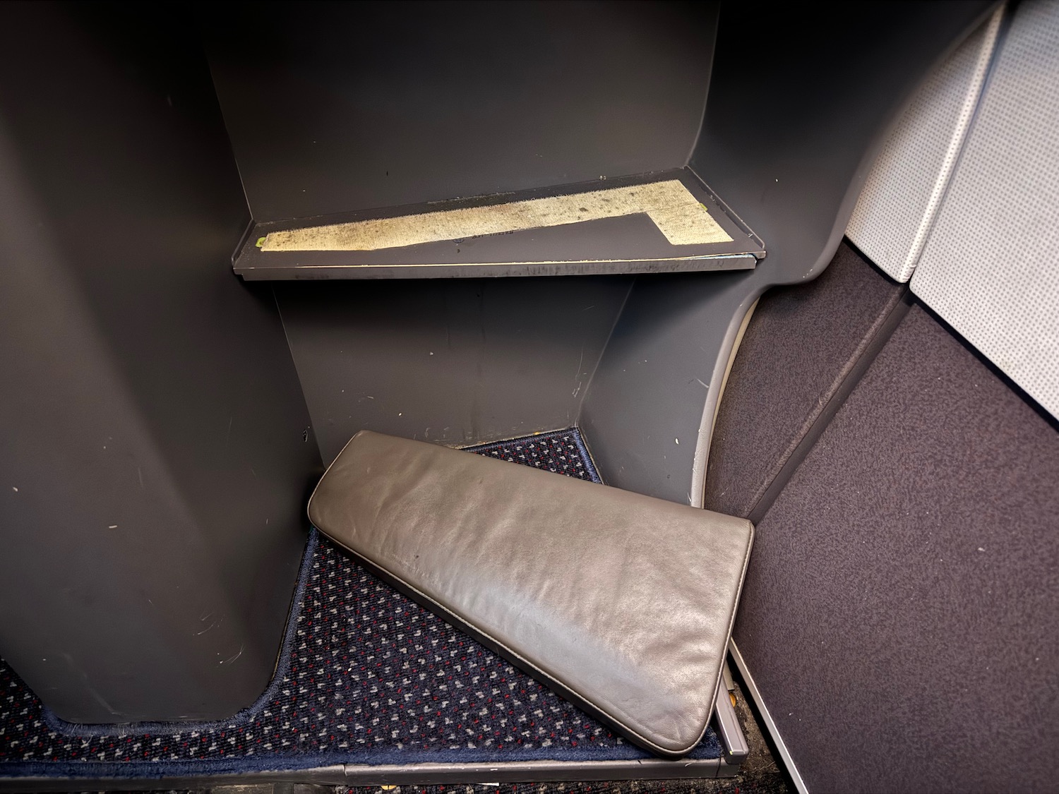 a grey object on a carpeted floor