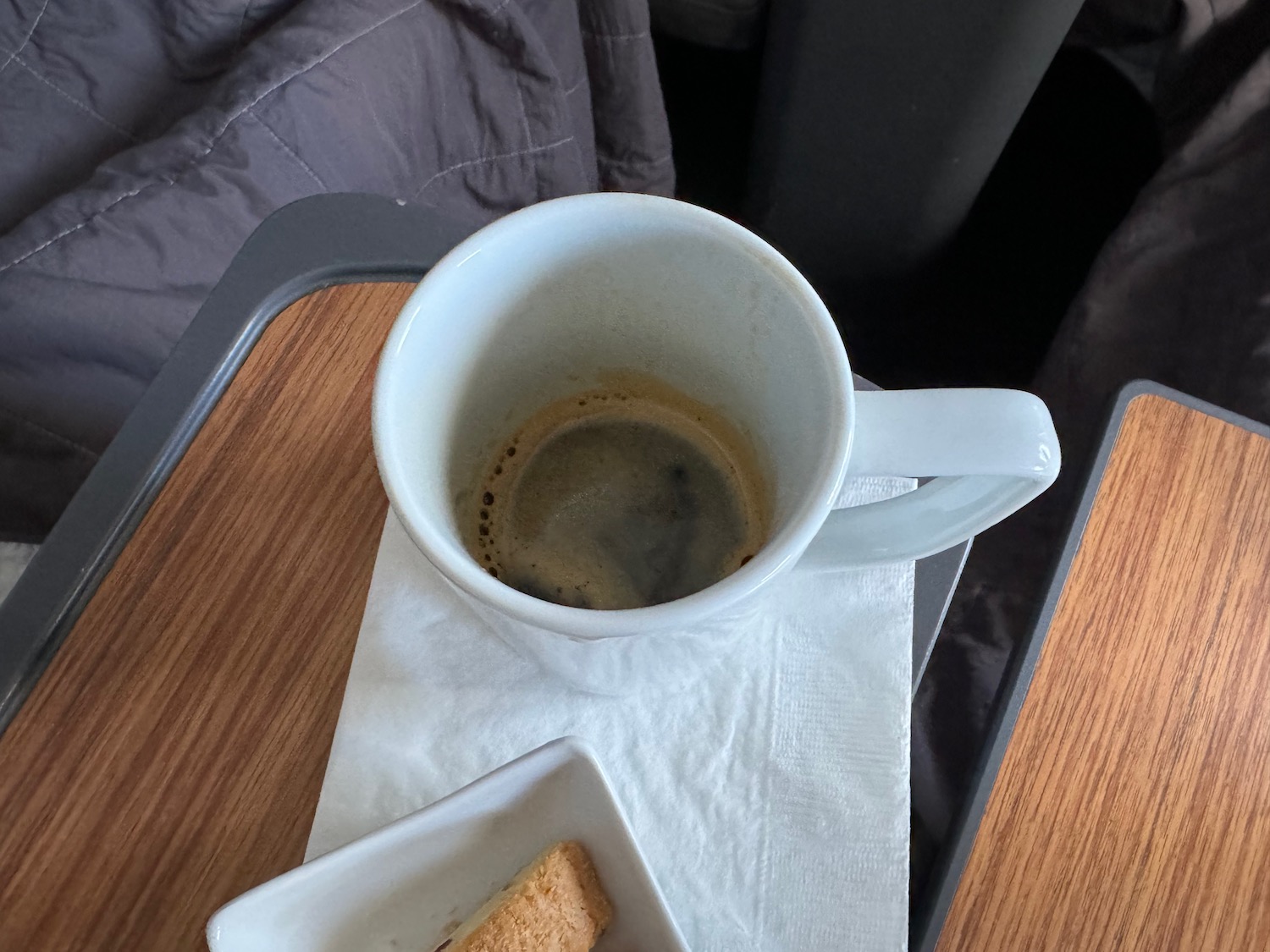 a cup of coffee and a plate of cookies on a table