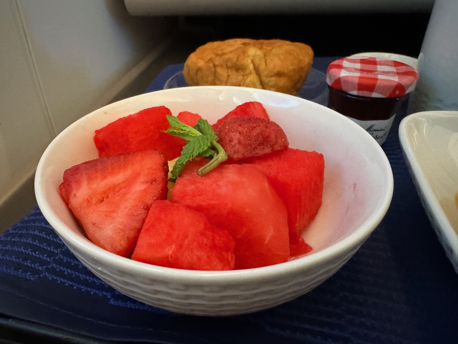 a bowl of fruit and a pastry