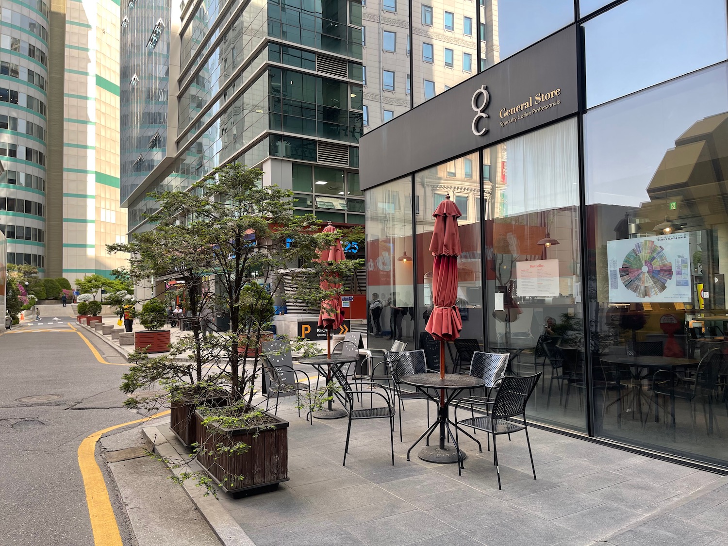 a sidewalk with tables and chairs outside of a building