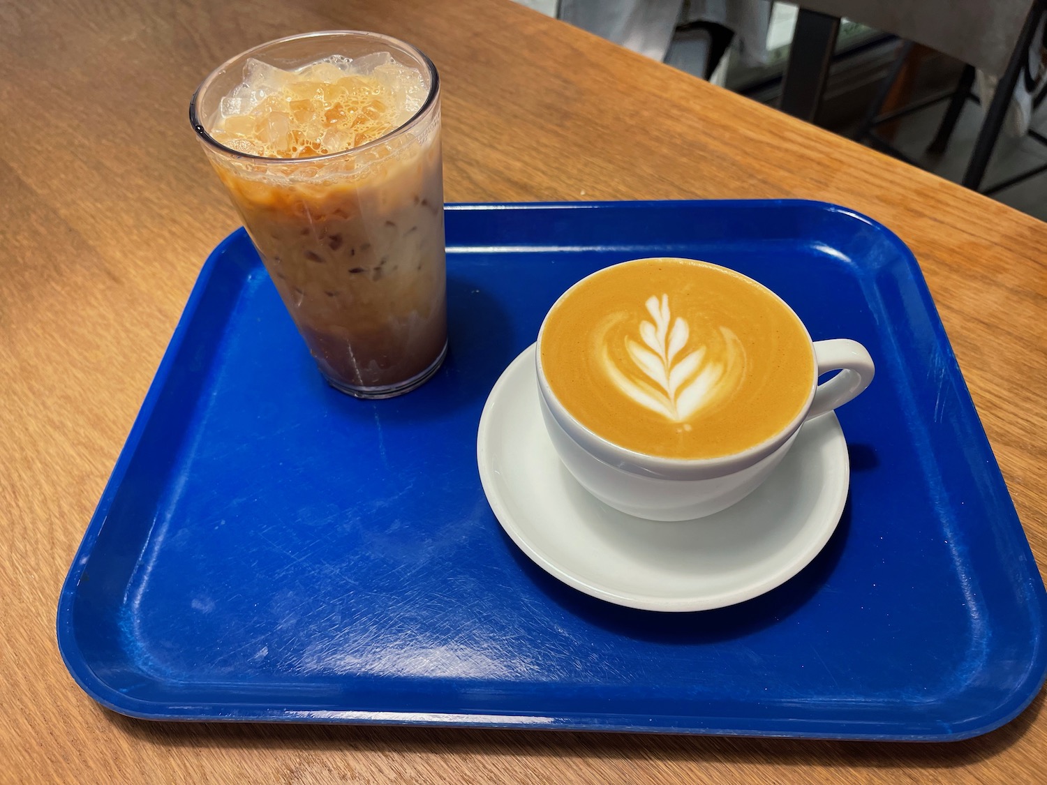 a cup of coffee and a drink on a tray