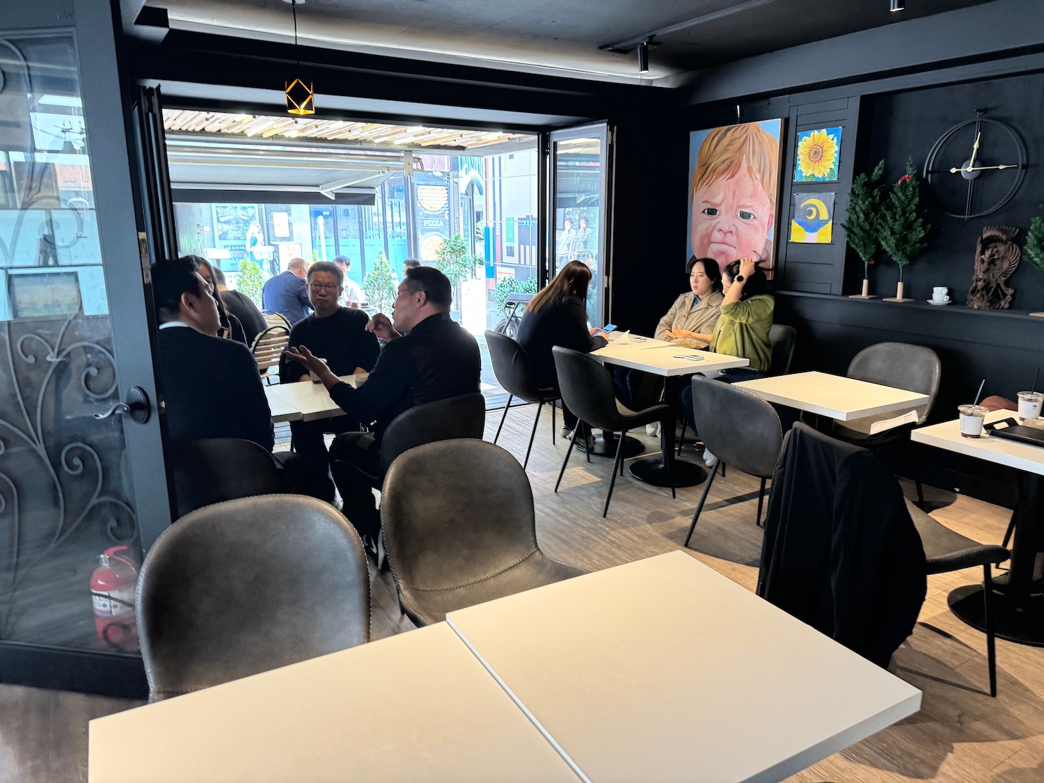 a group of people sitting at tables in a restaurant