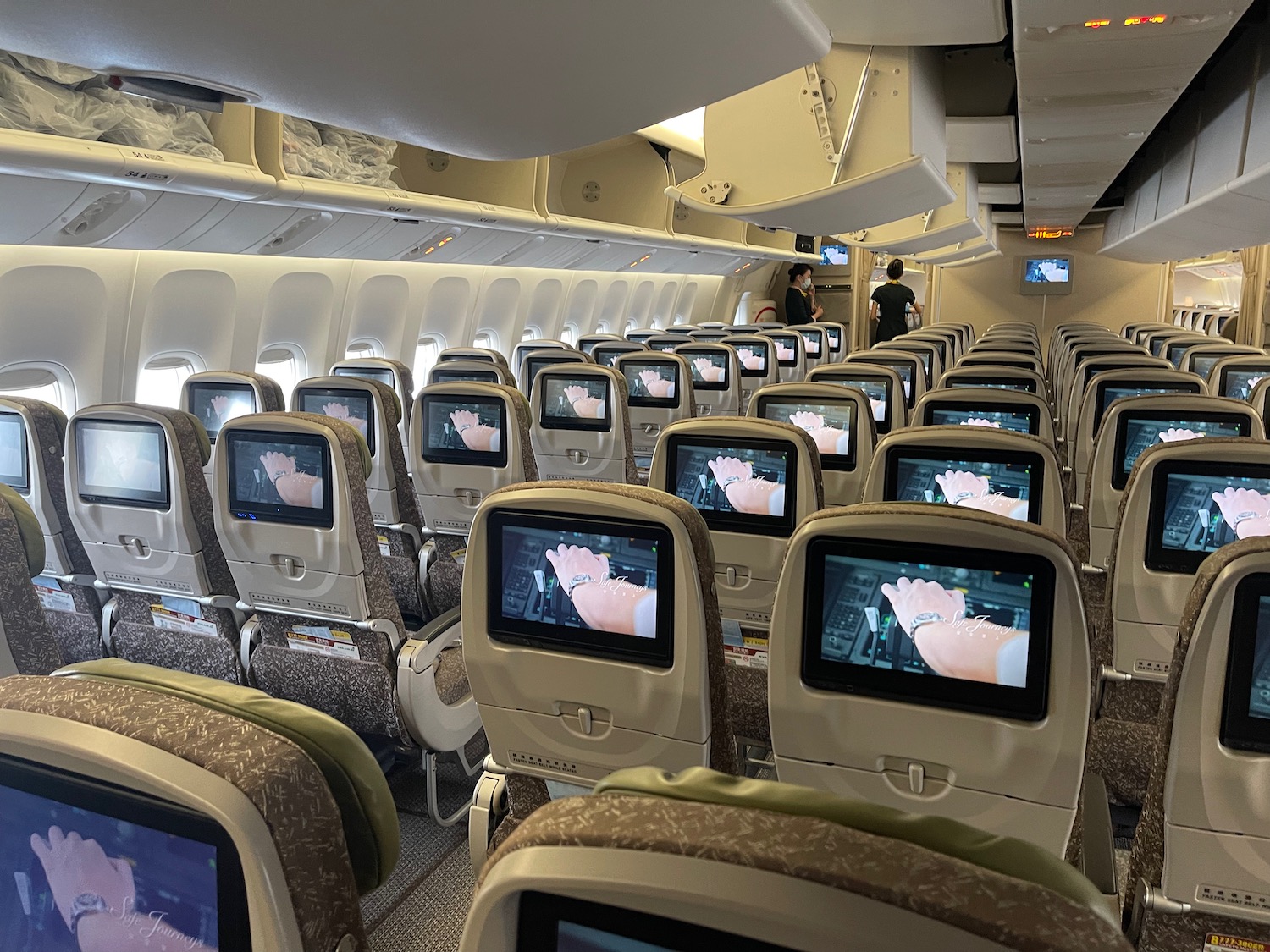 an airplane with rows of seats and monitors