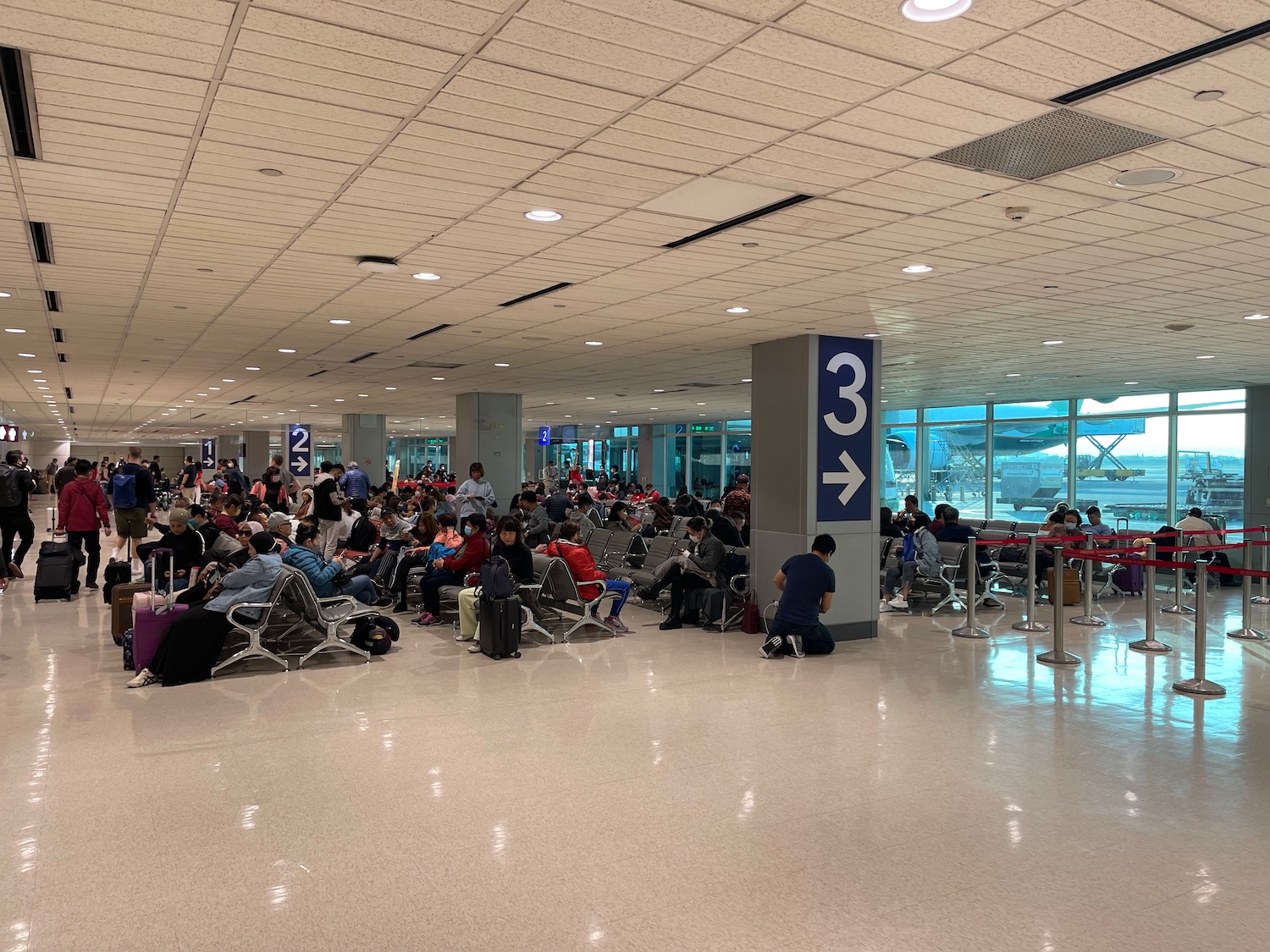 a group of people sitting on chairs in an airport