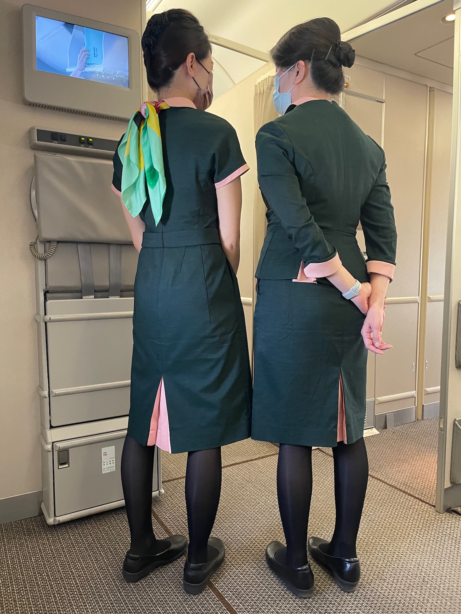 two women in uniforms and masks