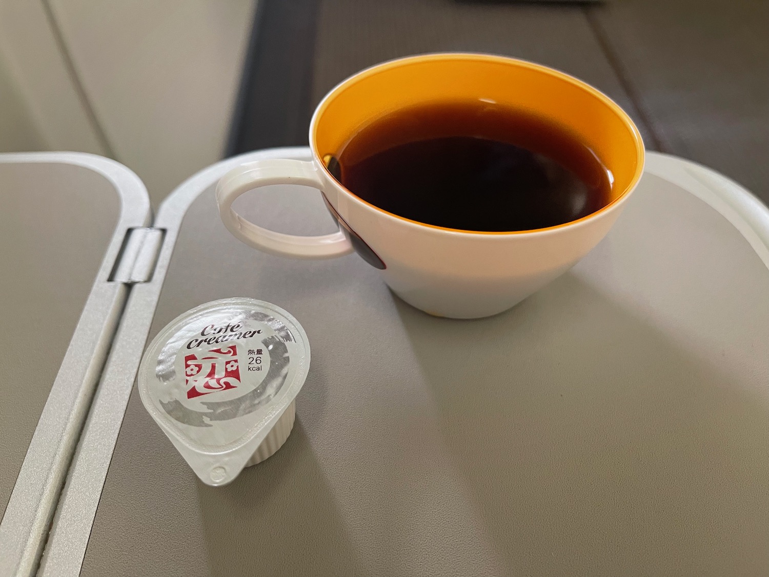 a cup of coffee and yoghurt on a table