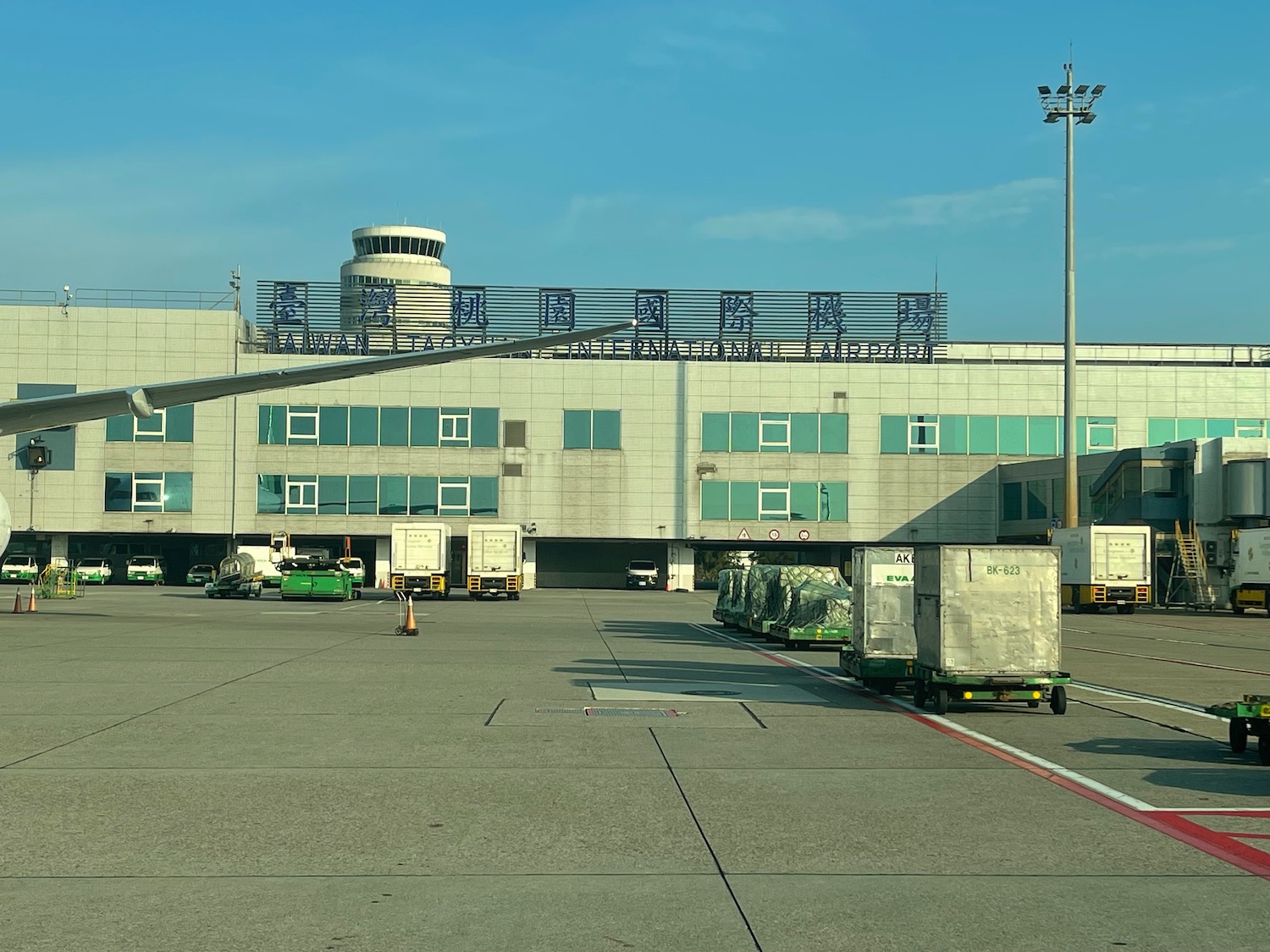 a large building with a few trucks parked in front of it