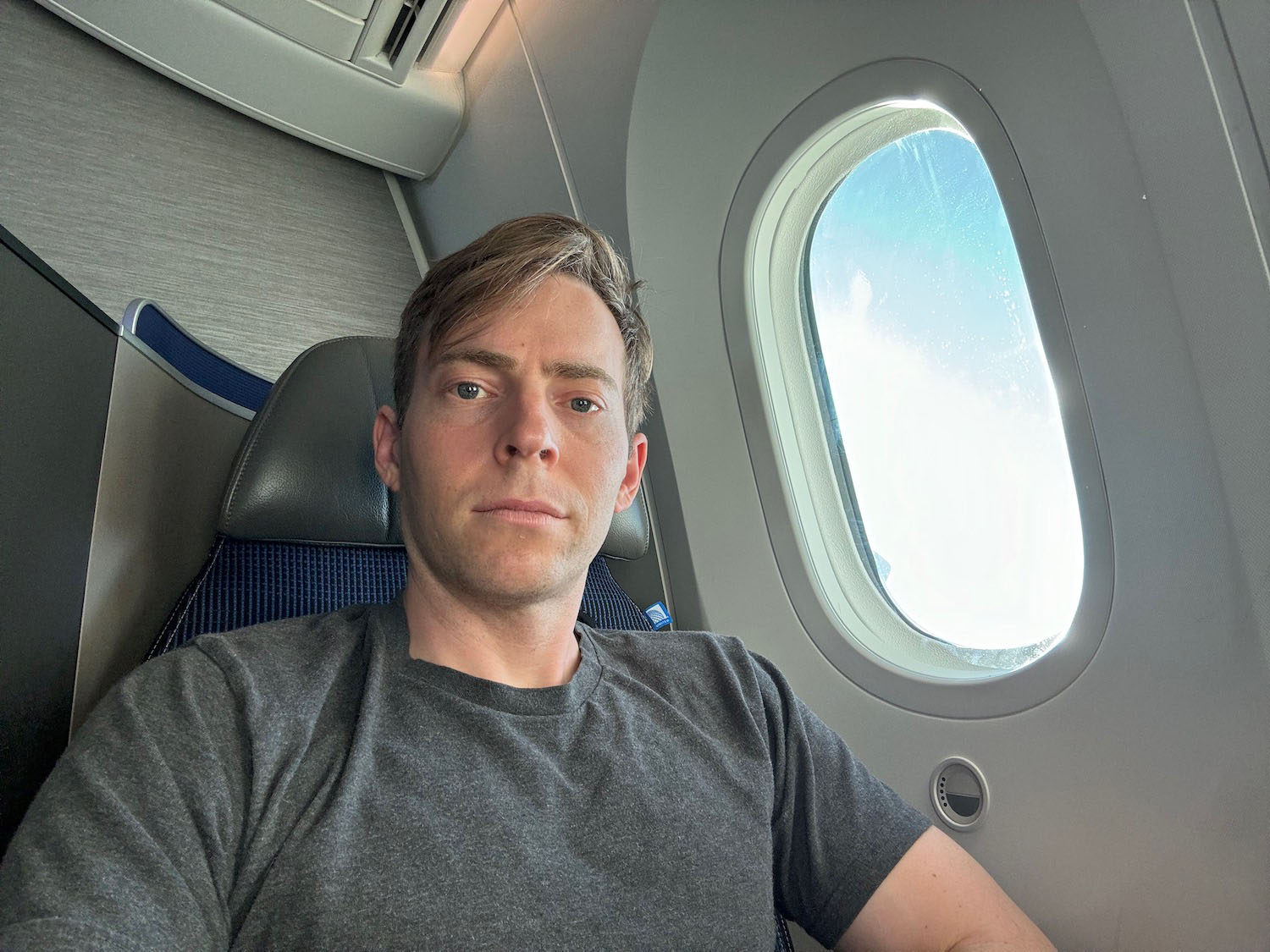 a man sitting in a chair with a window