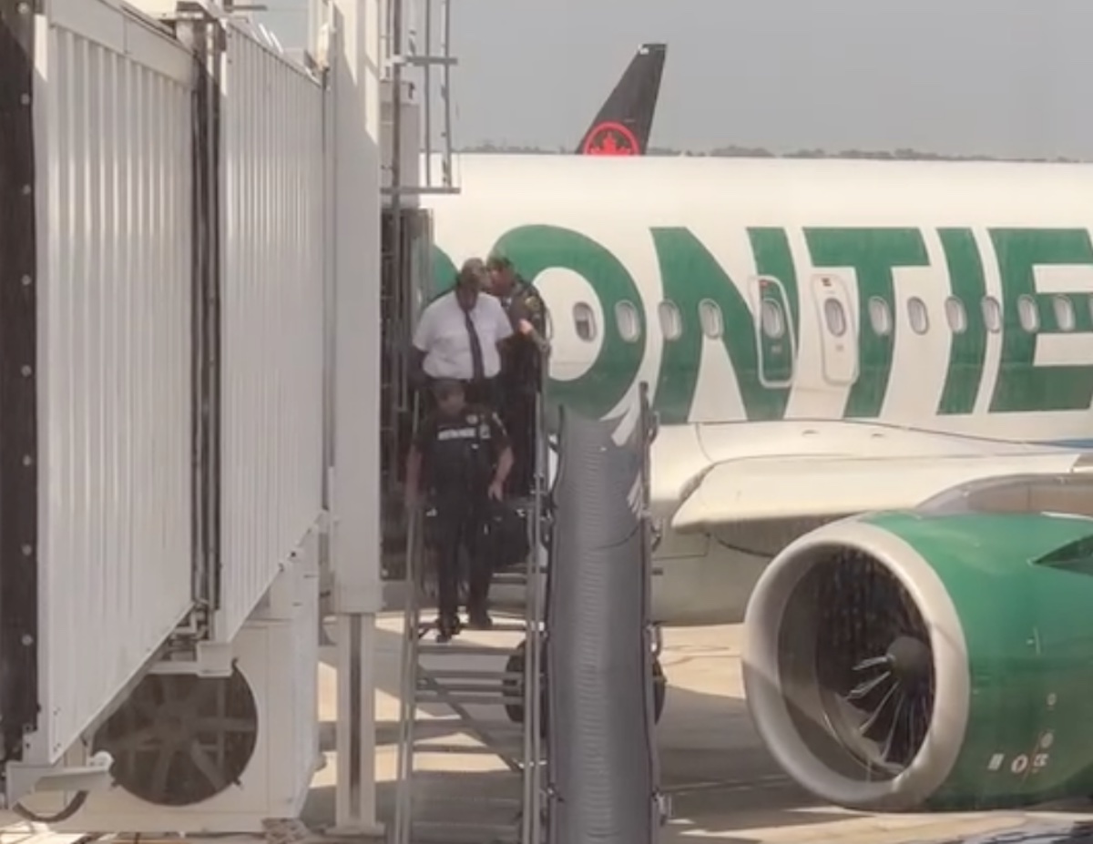 a group of people walking out of an airplane