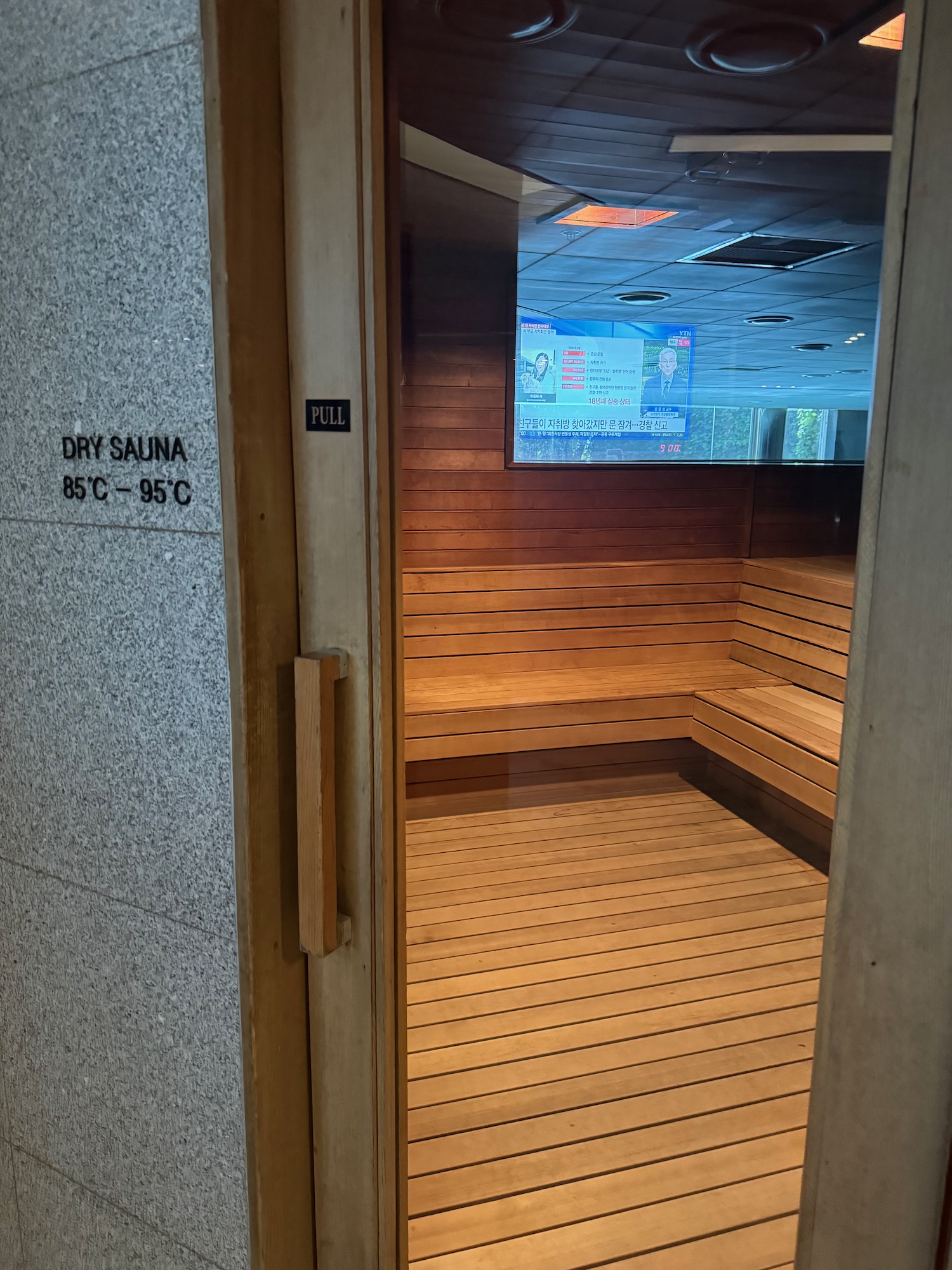 a wooden sauna door with a television