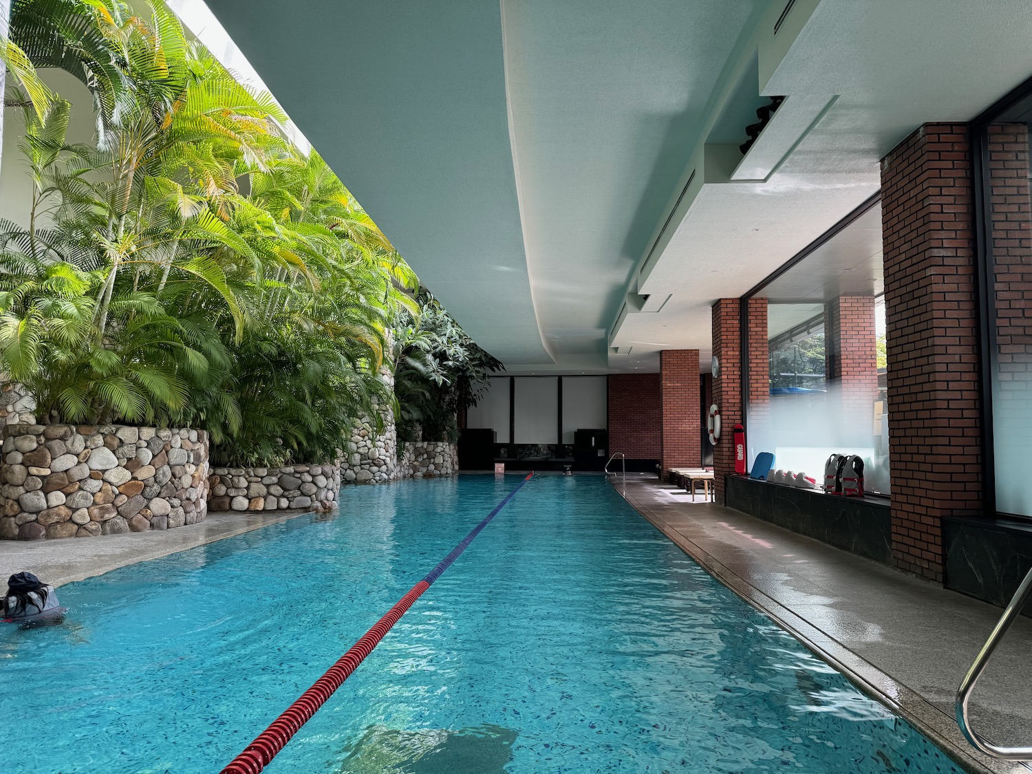 a swimming pool with trees and rocks