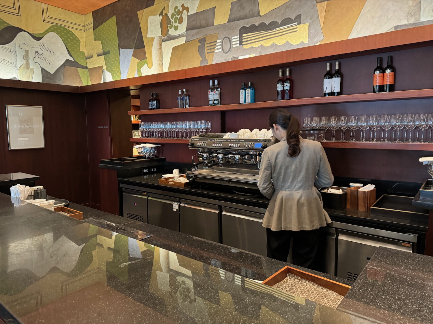 a woman standing at a counter in a restaurant