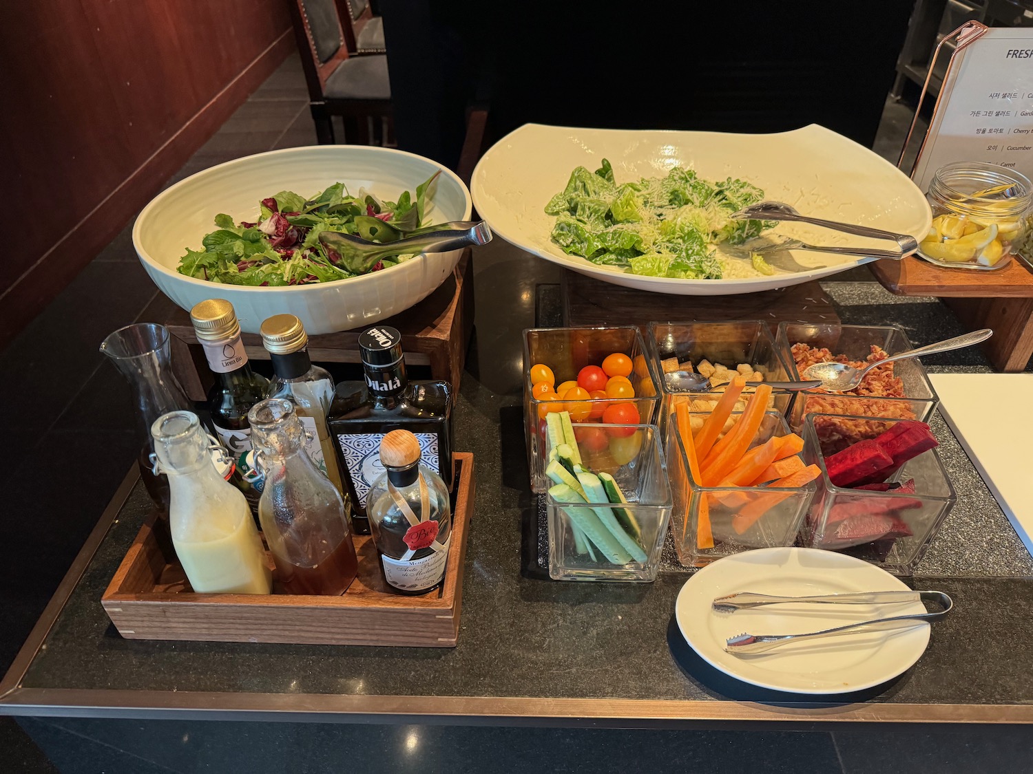 a table with bowls of food and bottles of alcohol