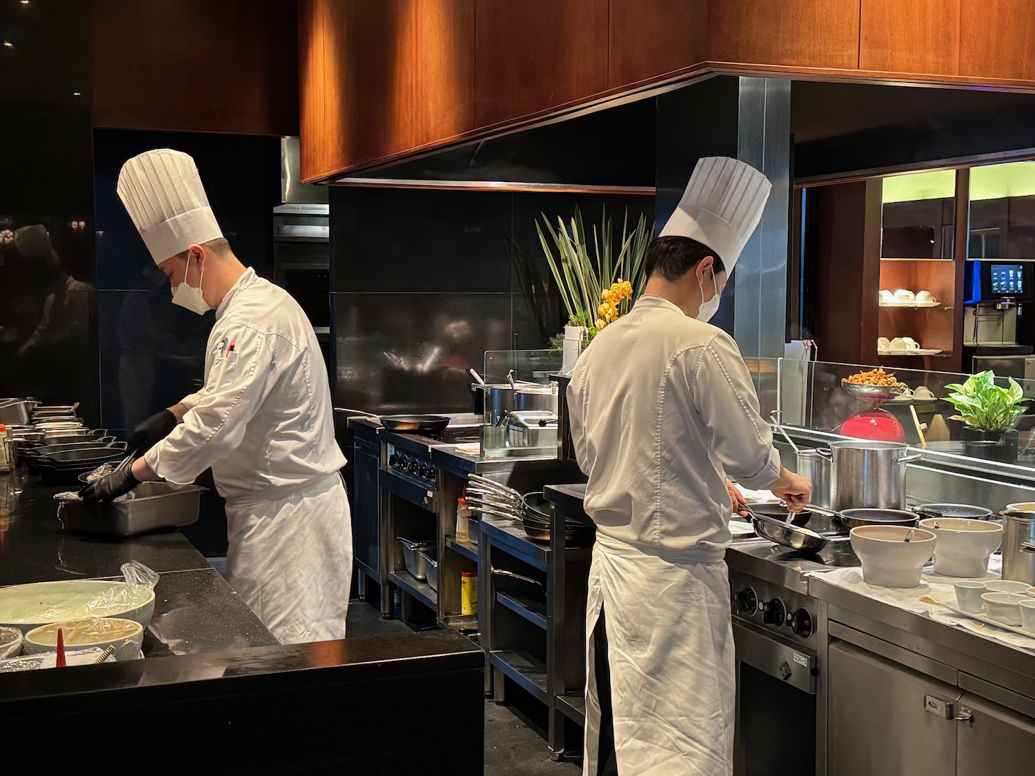 two chefs cooking in a kitchen