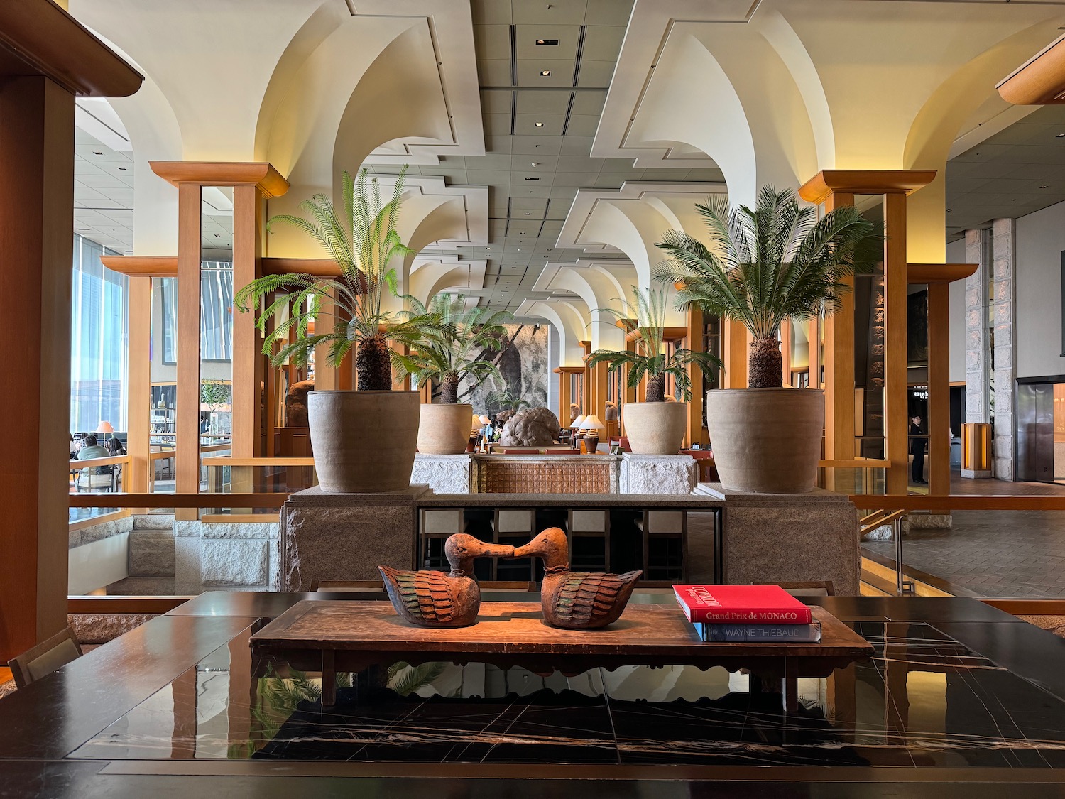 a room with a table and potted plants