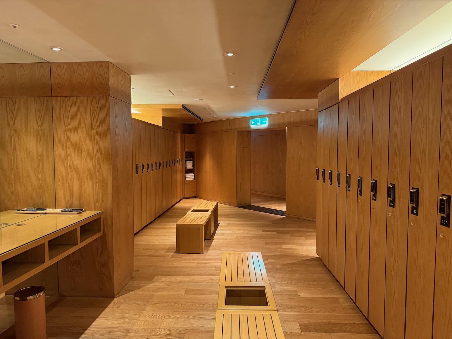 a wooden locker room with benches and a wood floor