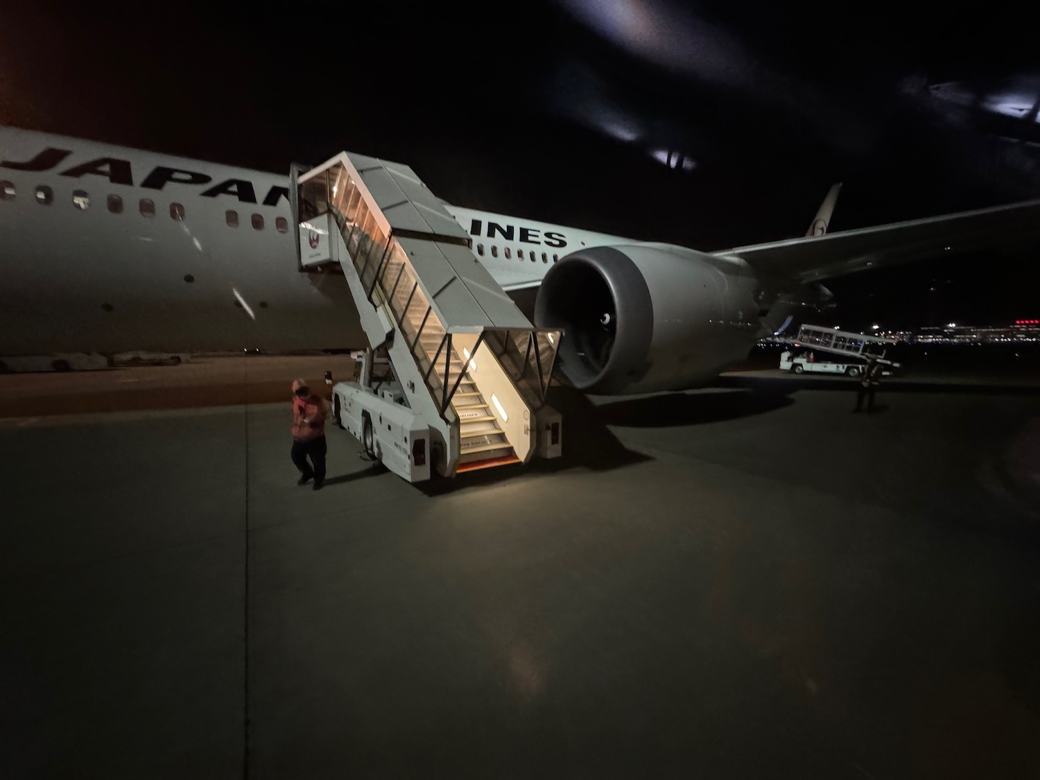 a person walking down a staircase to an airplane