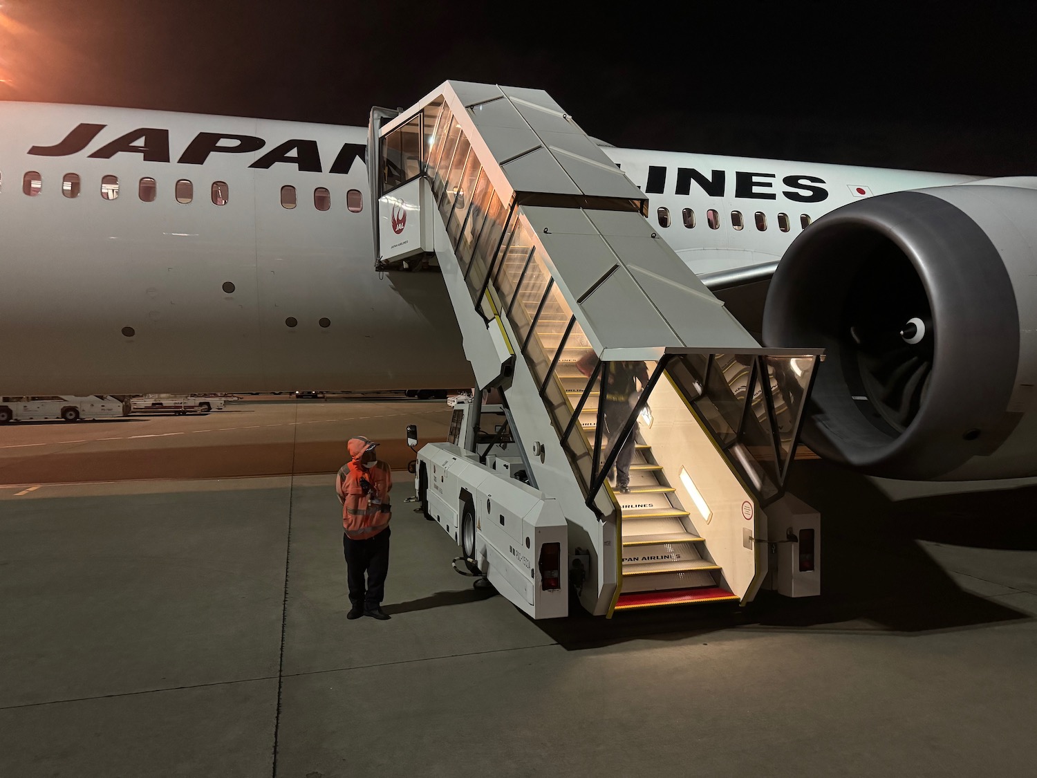 a person standing next to a plane