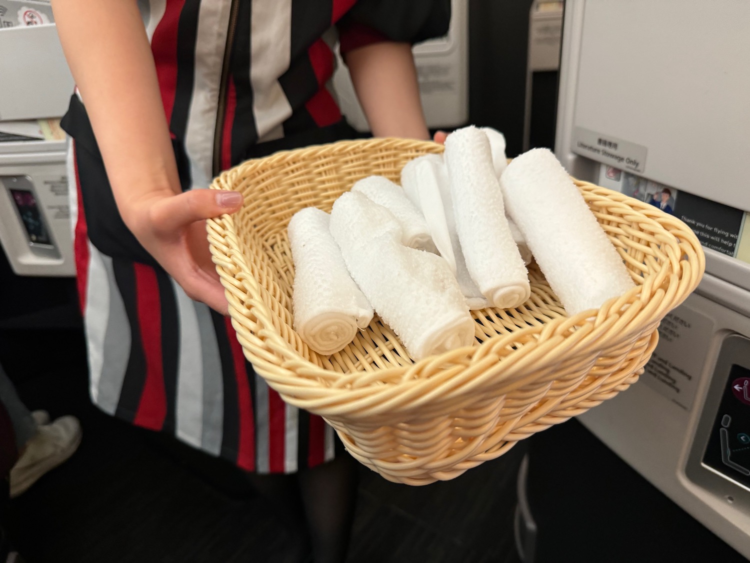 a person holding a basket of towels