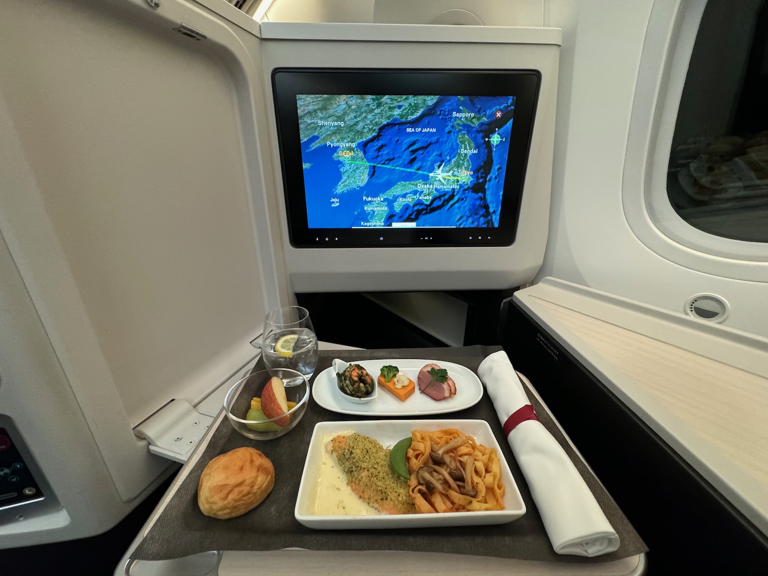 a tray with food on it and a television on the side of the table