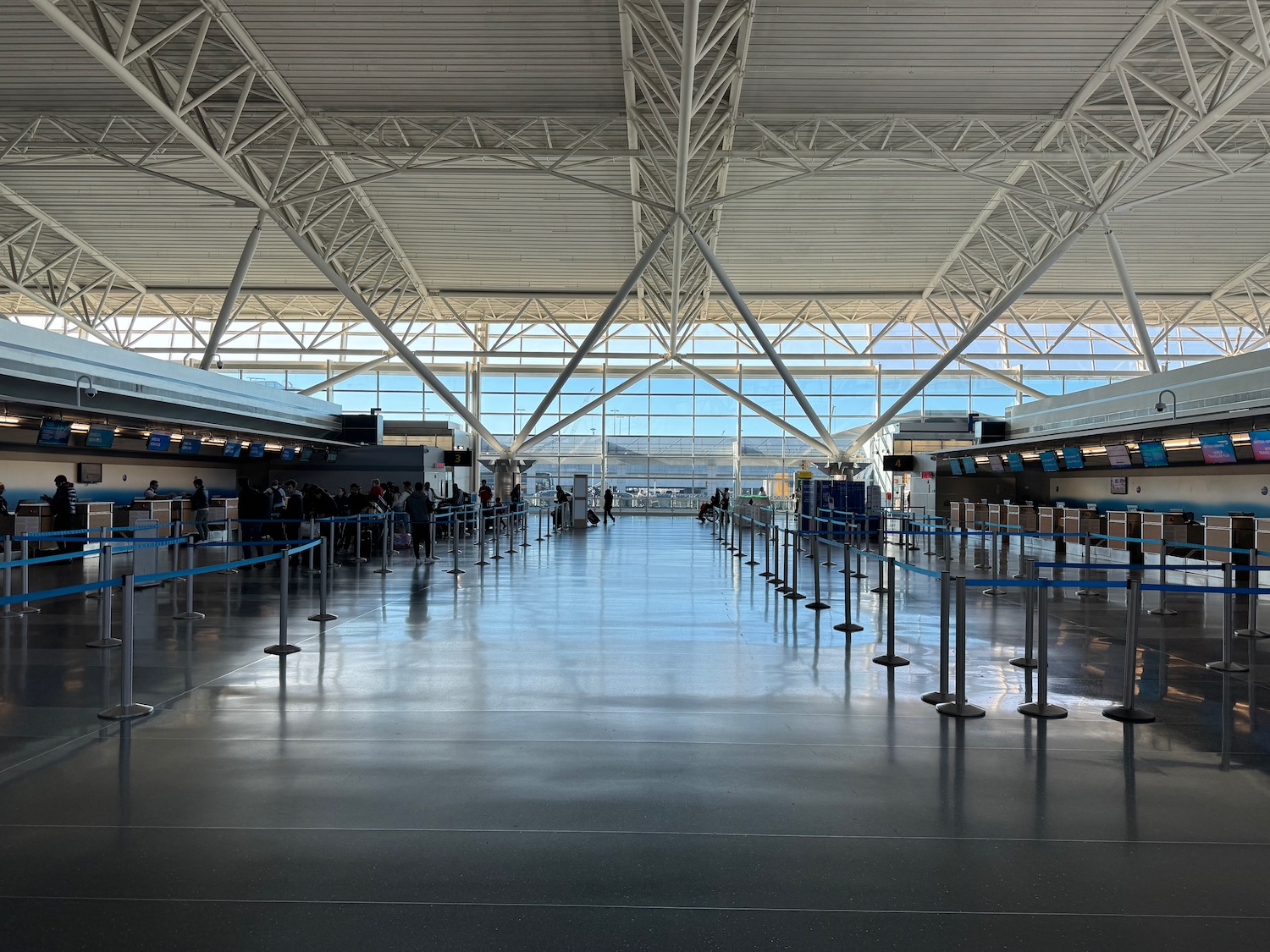 a large airport terminal with people walking around