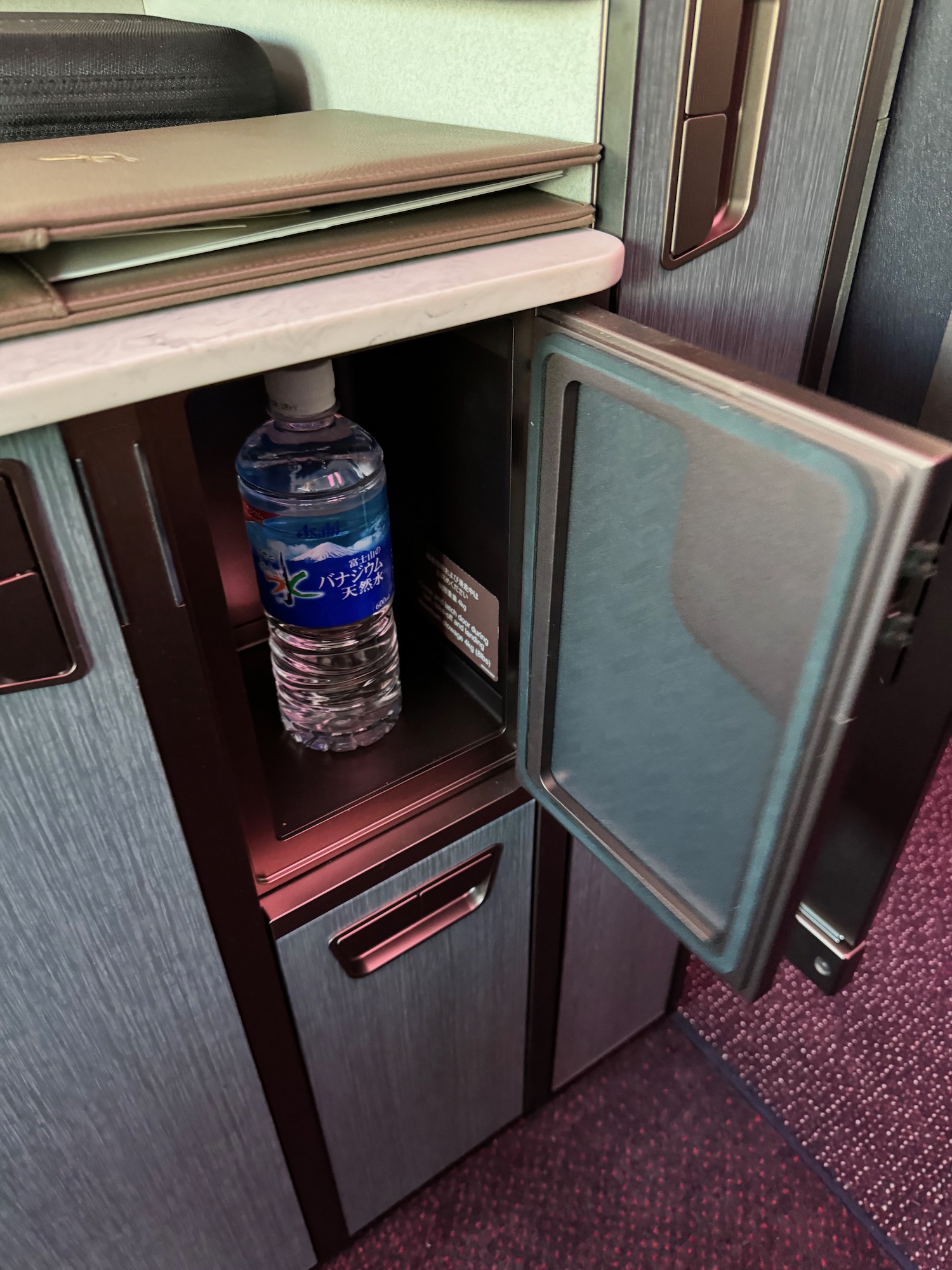 a bottle of water under a cabinet