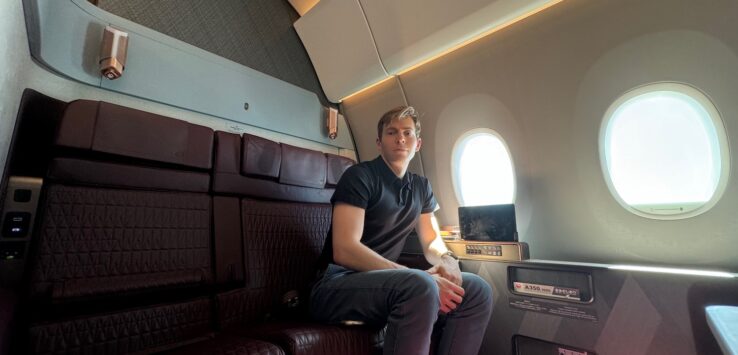 a man sitting on a seat in an airplane