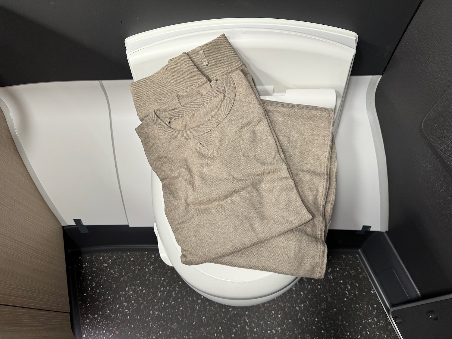 a folded clothes on a toilet