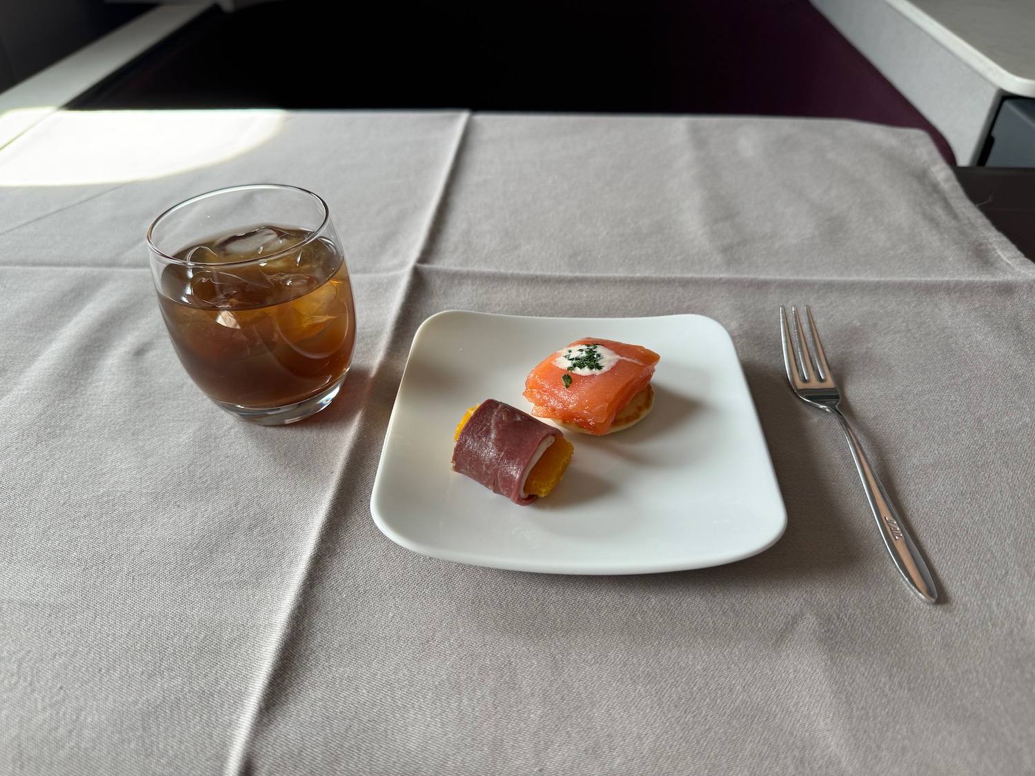 a plate of food and a glass of liquid on a table