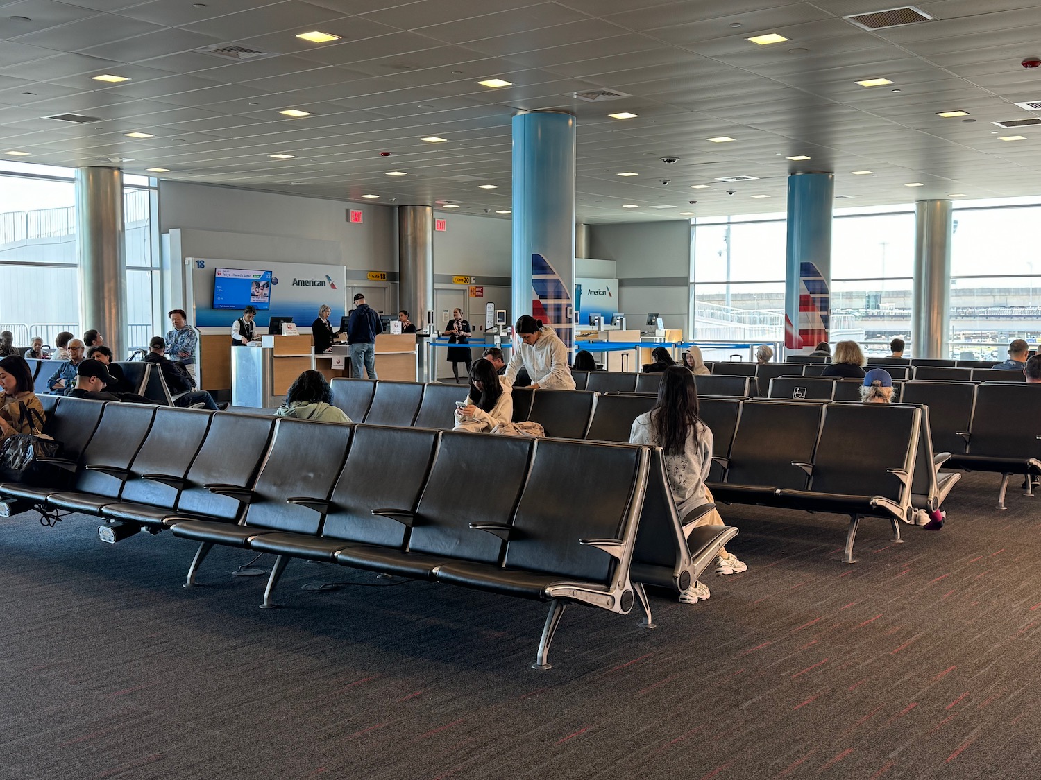 people sitting in chairs in an airport