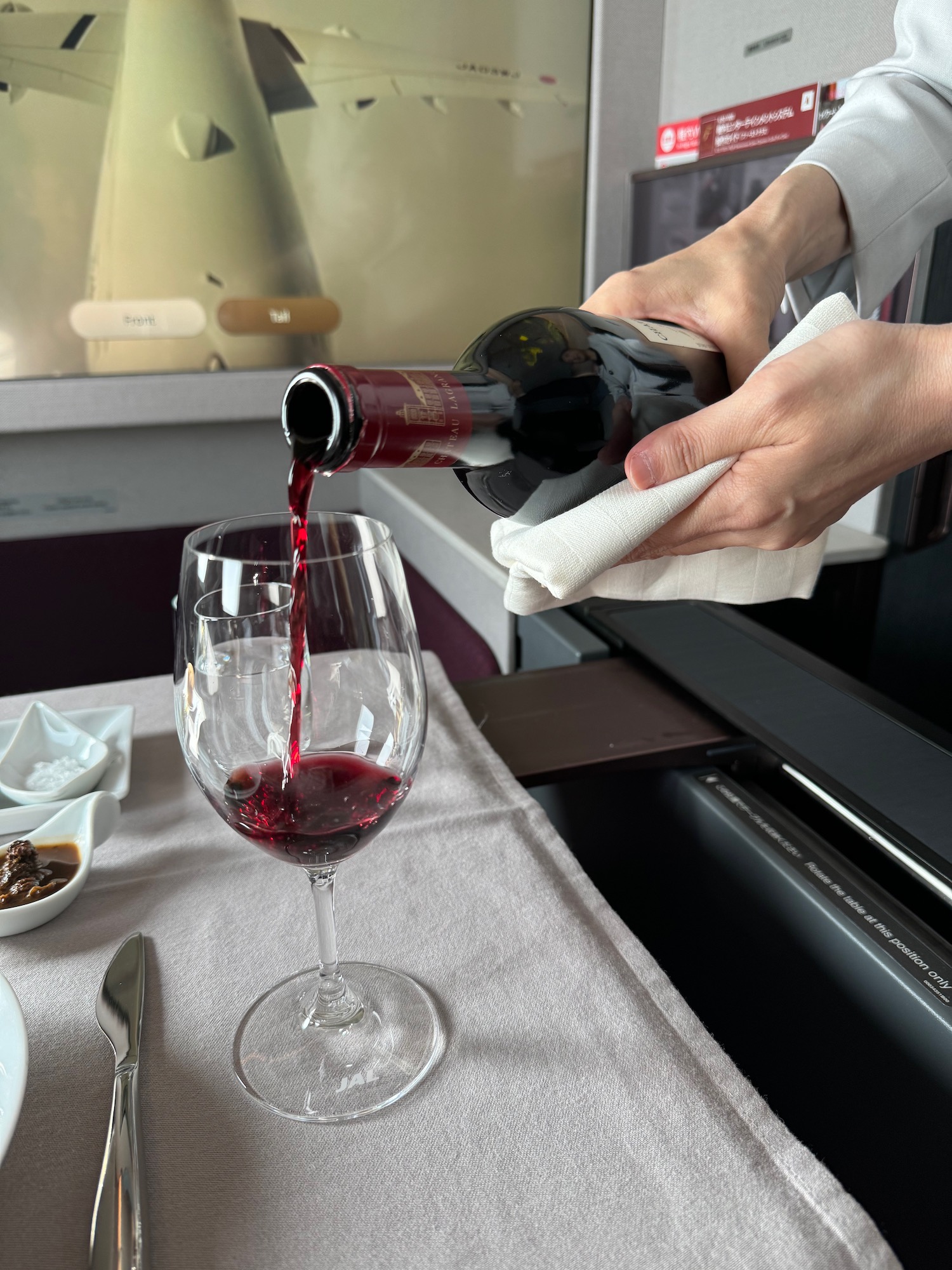 a person pouring wine into a glass