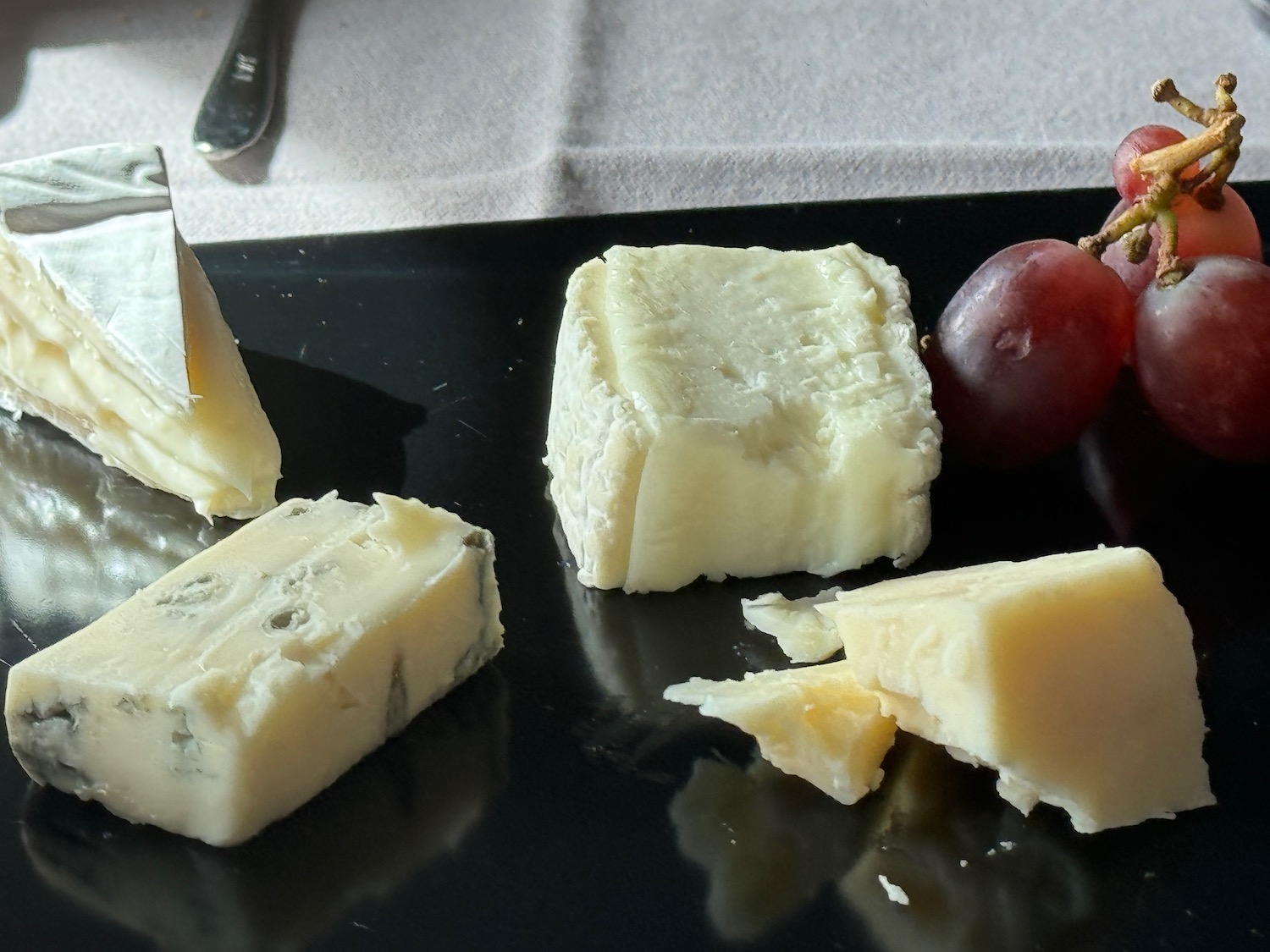 a plate of cheese and grapes