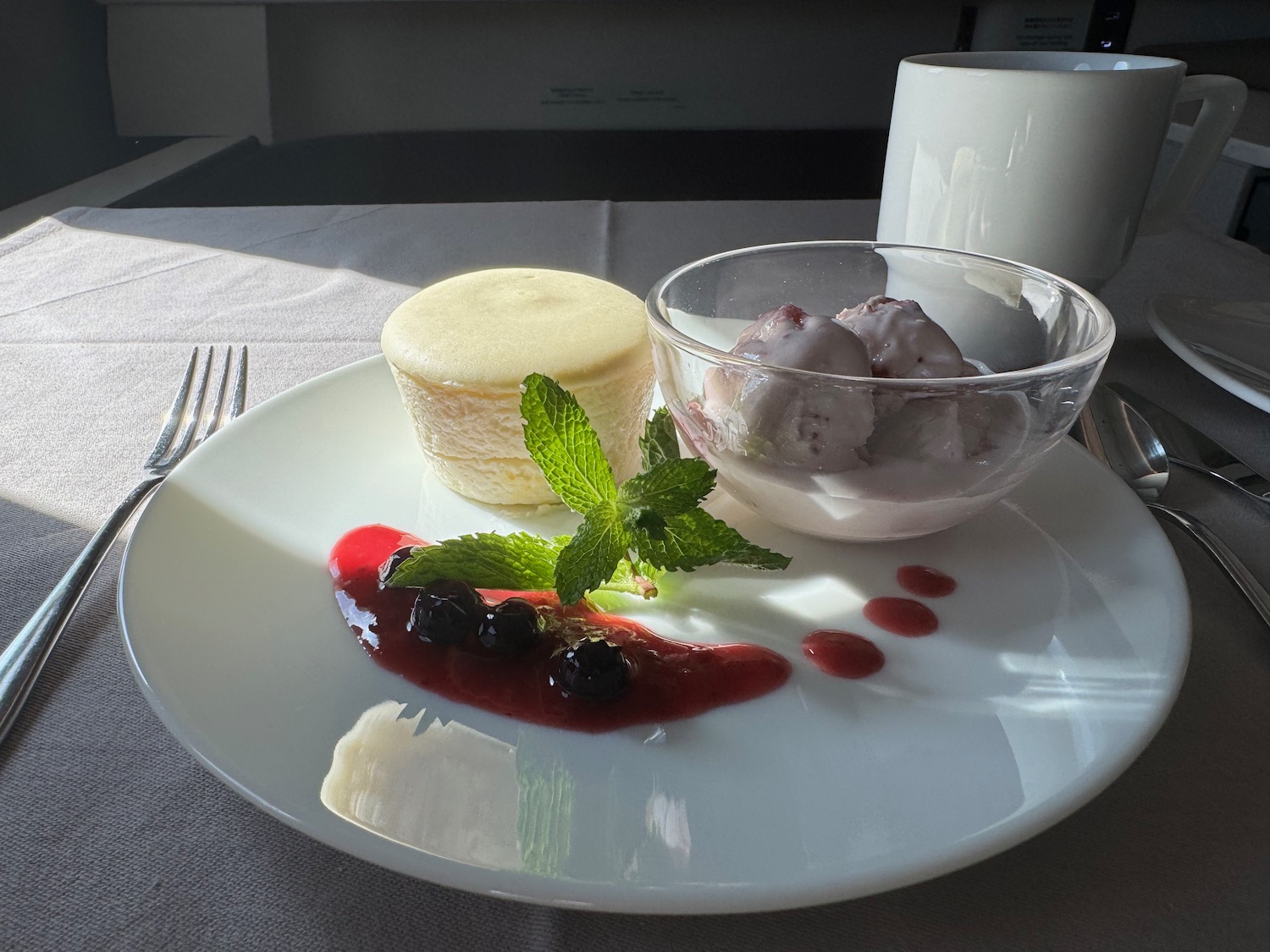 a plate of dessert with ice cream and berries