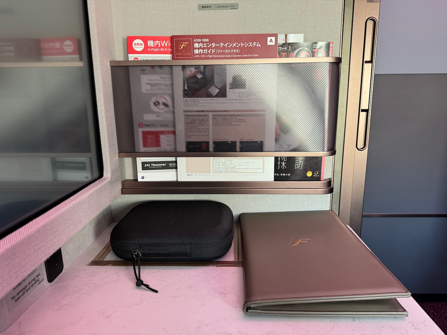 a black case and a brown folder on a table