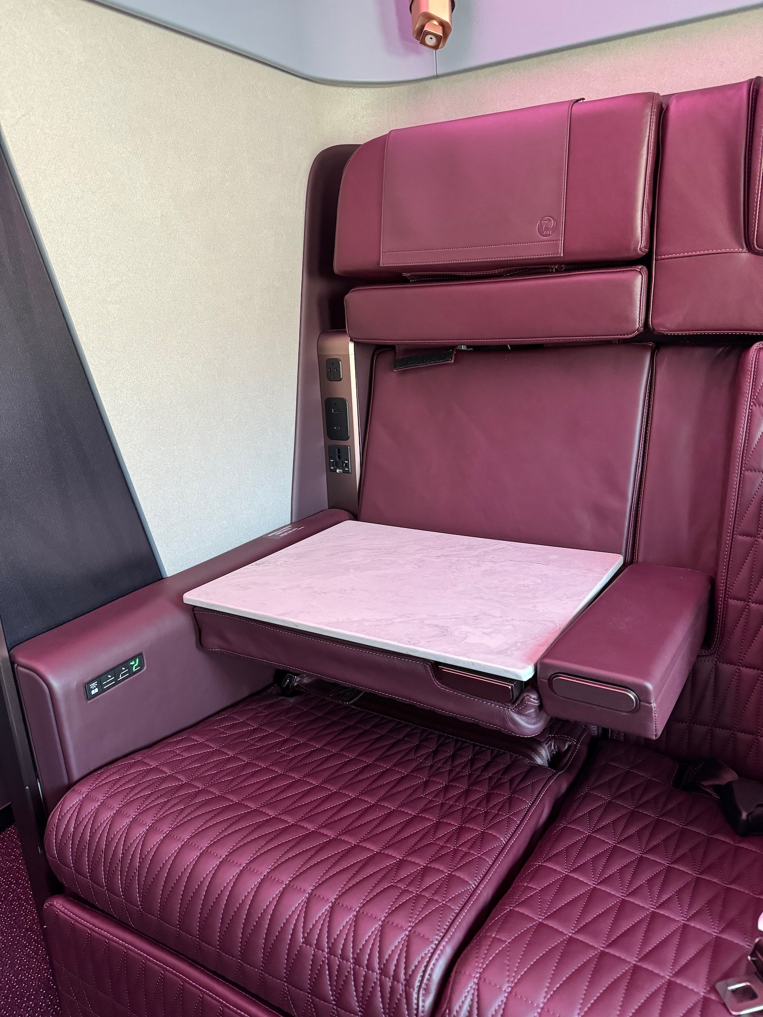 a red leather seat with a table